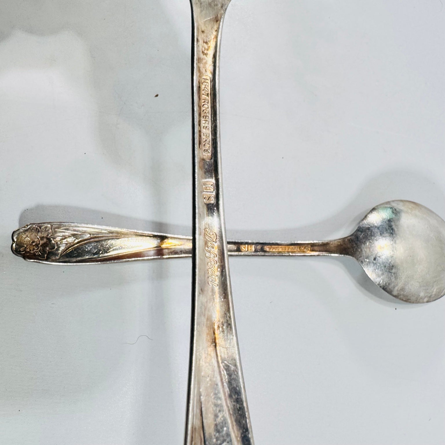 Close view of 1847 Rogers Bros IS Daffodil marks on silverplate spoon