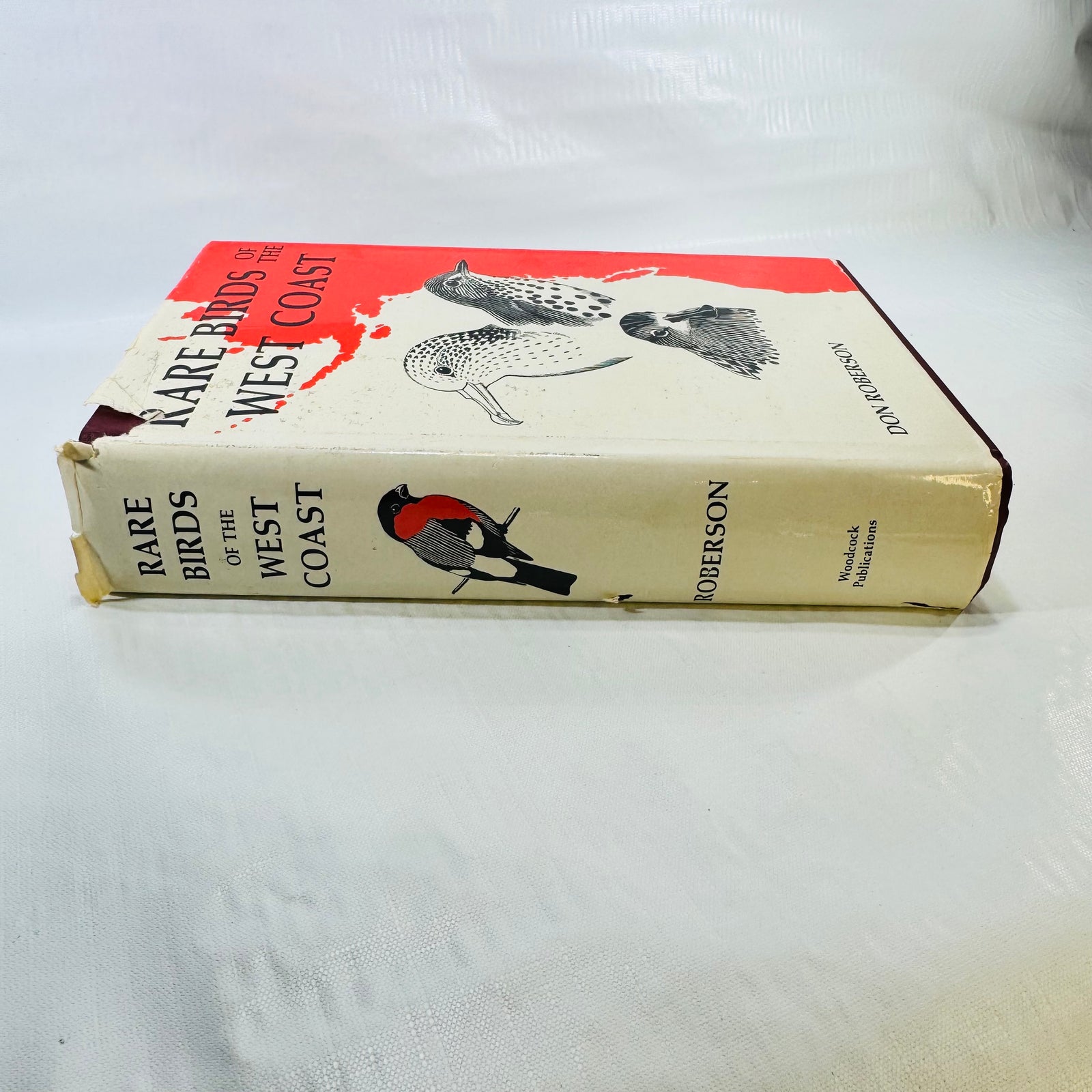 Jacket spine with tears and wear