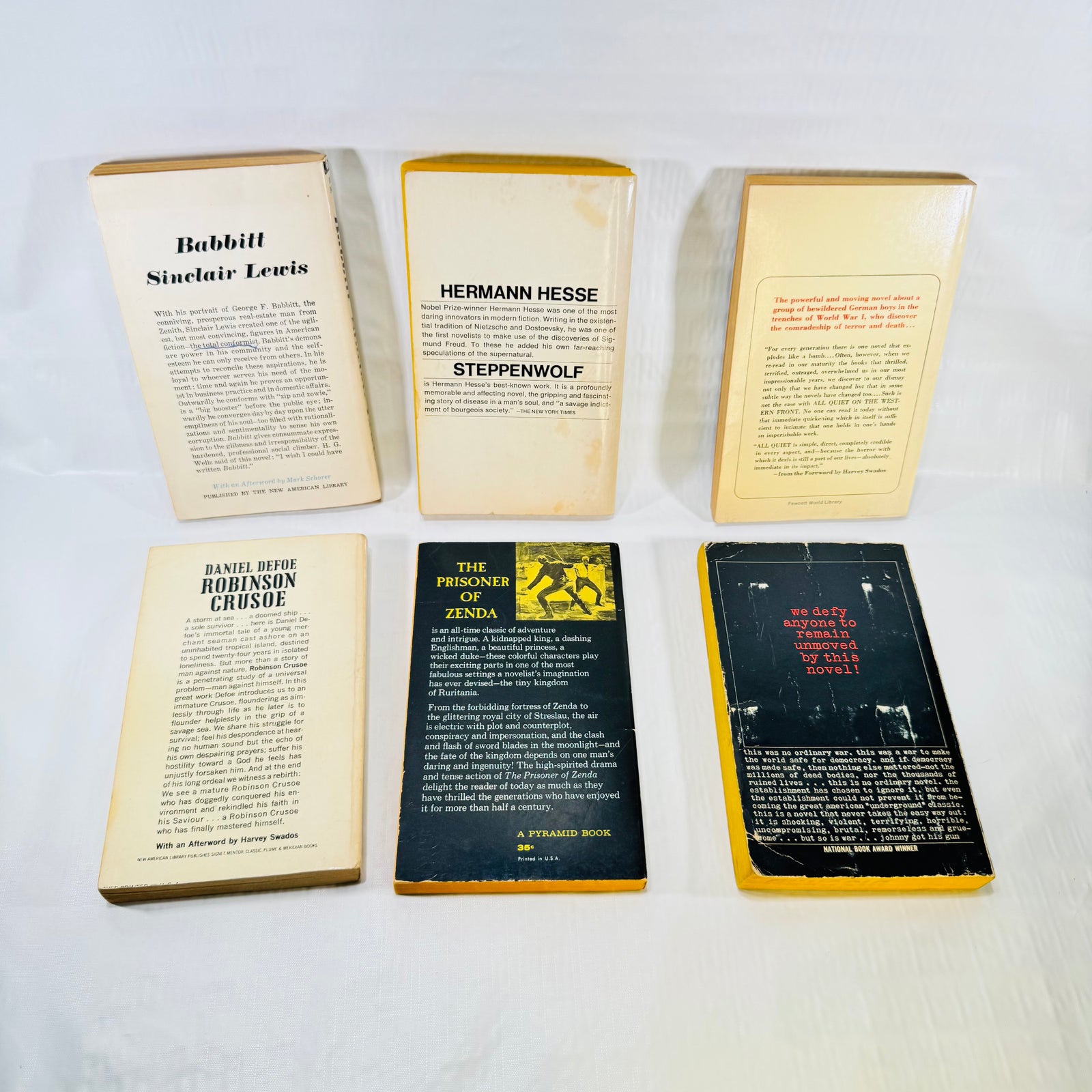 Six paperback books, back covers and wear