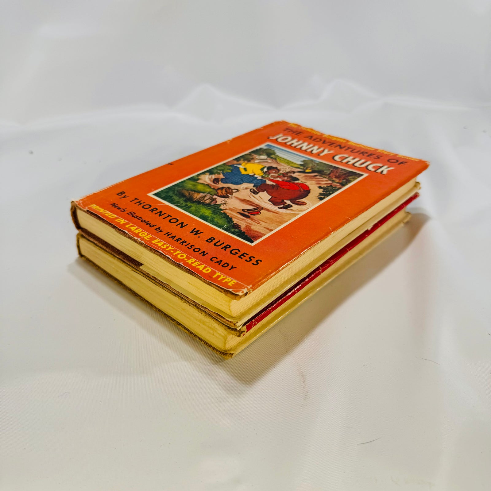 Both Burgess books stacked, showing the Johnny Chuck jacket and page edges