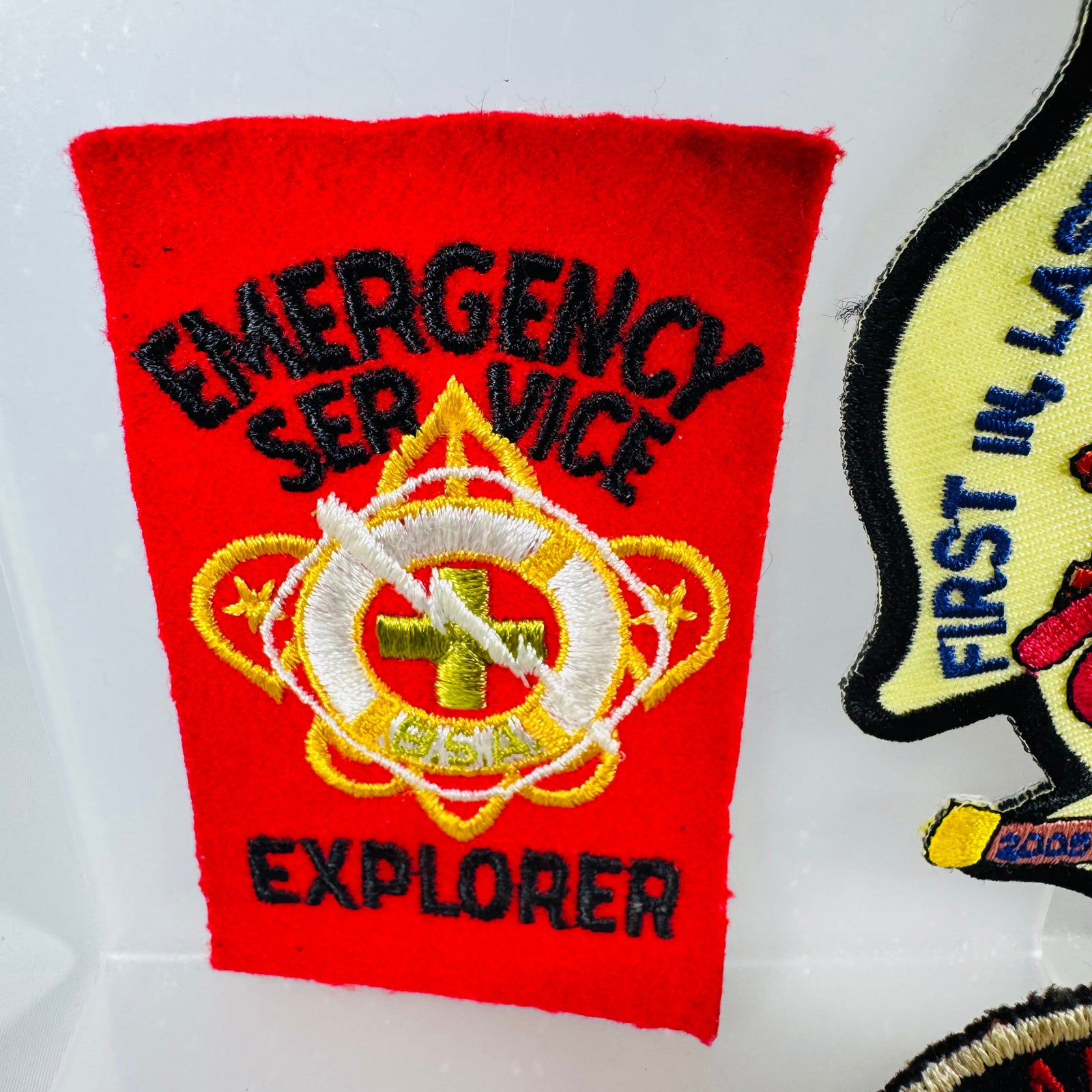 Red patch with 'Emergency Service Explorer' text and emblem on a white background