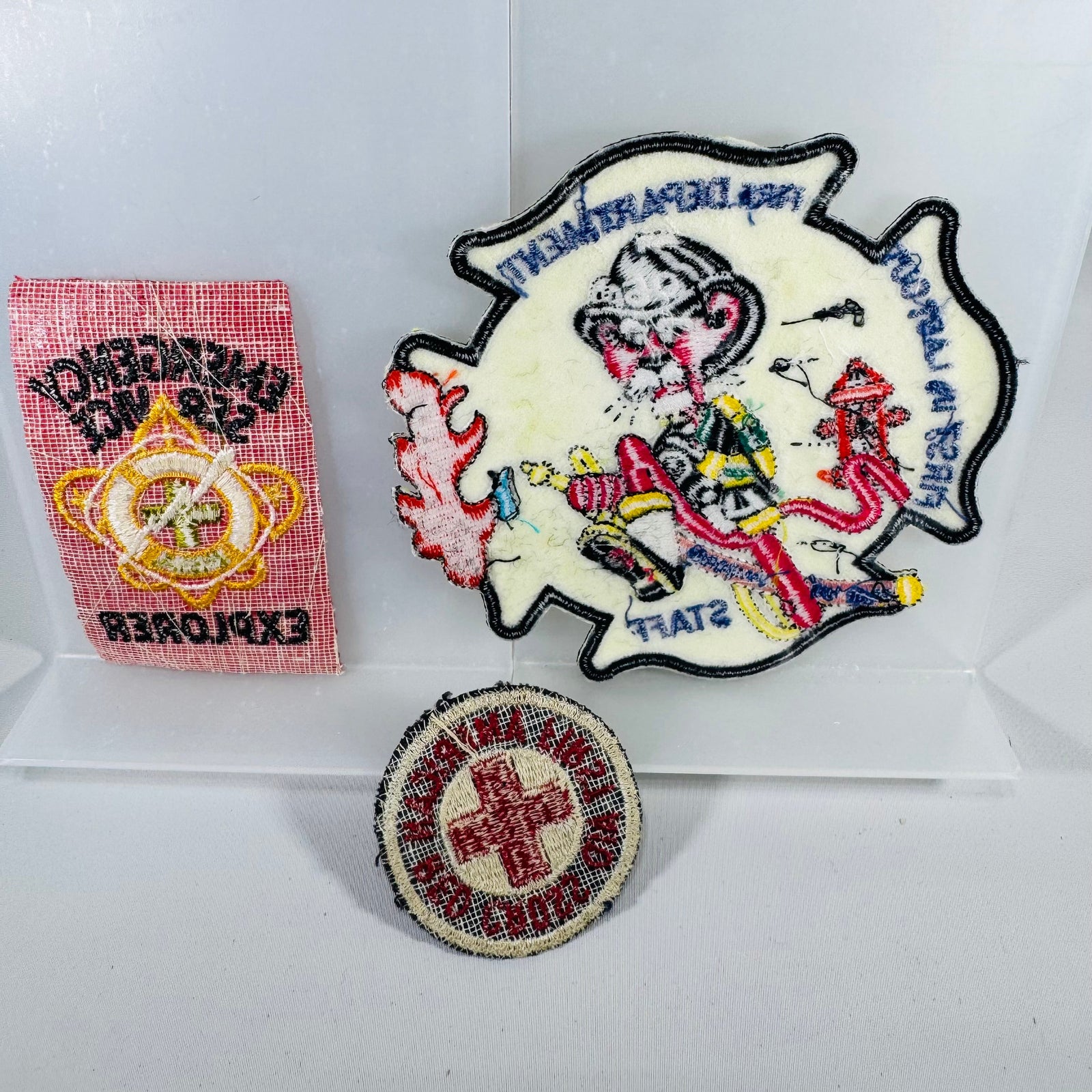 Three embroidered patches on a white background