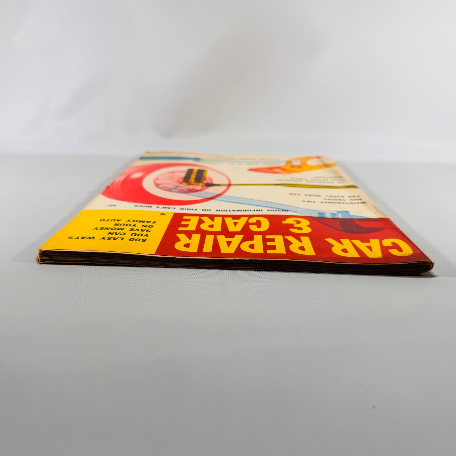 Car Repair and Care 1950s lying flat, front edge view
