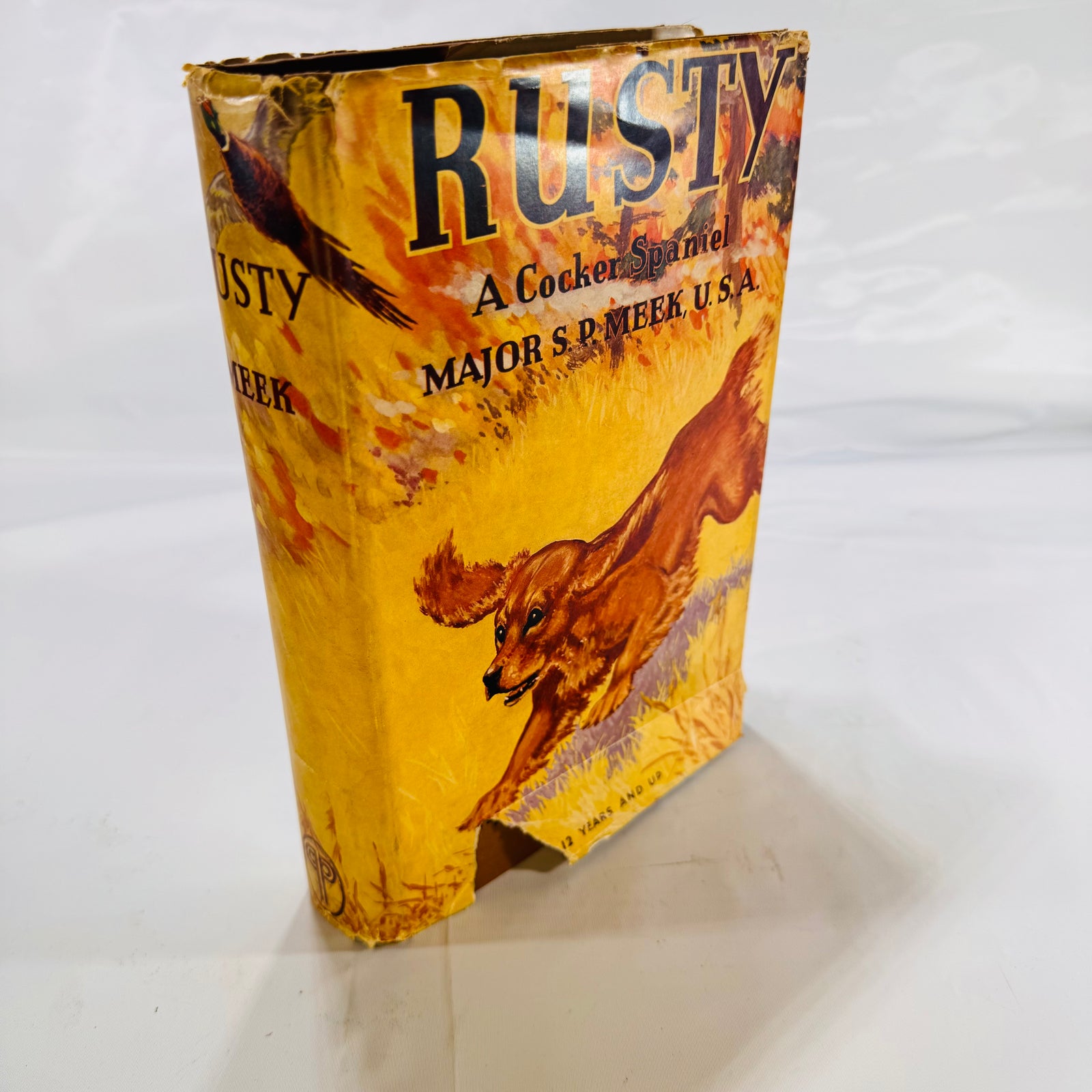 Rusty, A Cocker Spaniel 1942, front of the pictorial dust jacket with a running spaniel