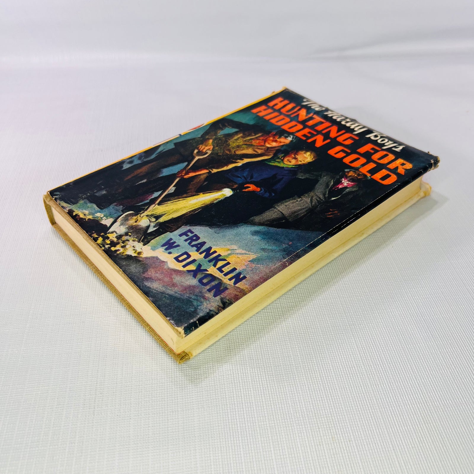 Hunting for Hidden Gold 1928 lying flat, showing the jacket front and page edges