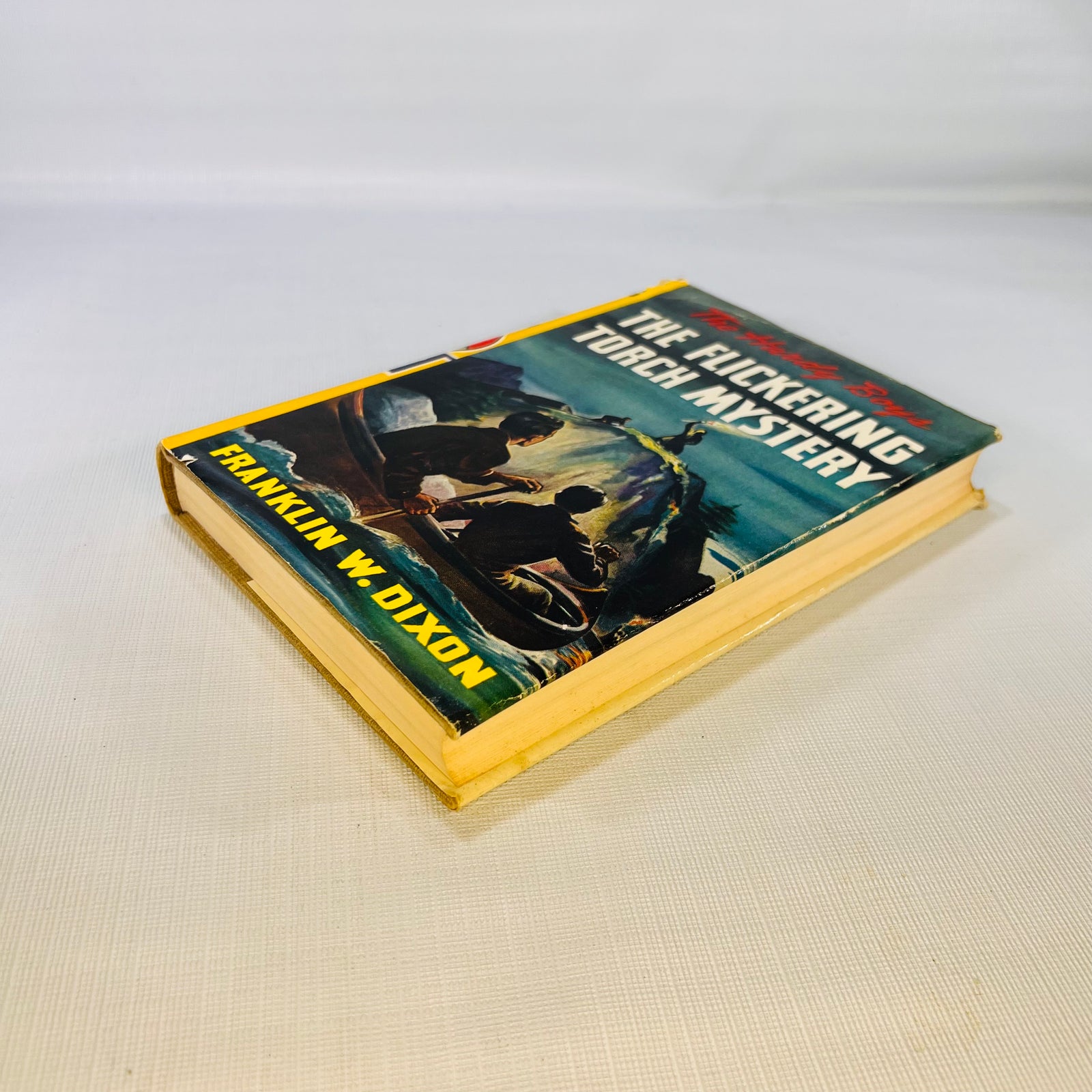 The Flickering Torch Mystery 1943 lying flat, showing the jacket front and page edges