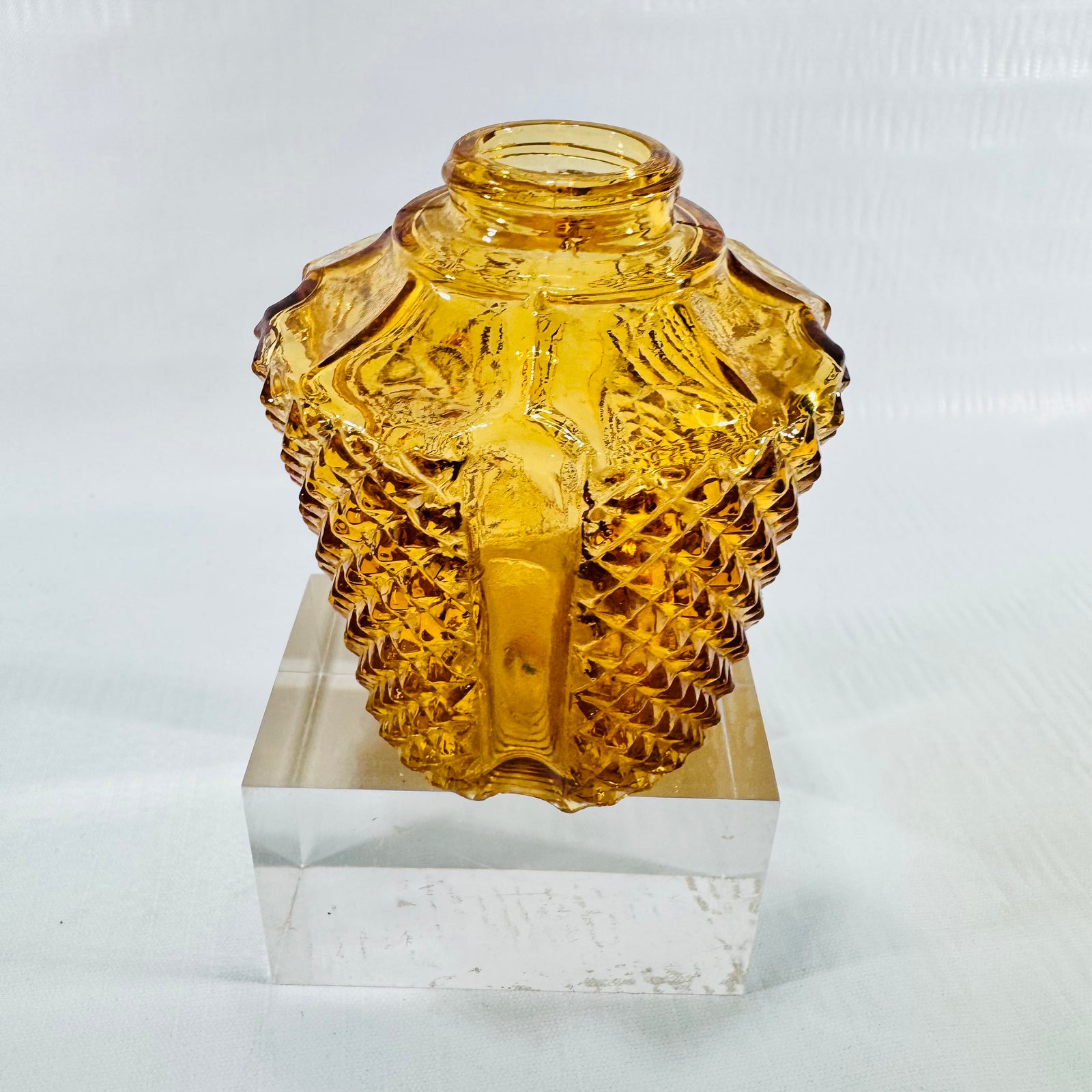 Side view of a small amber diamond point glass light shade