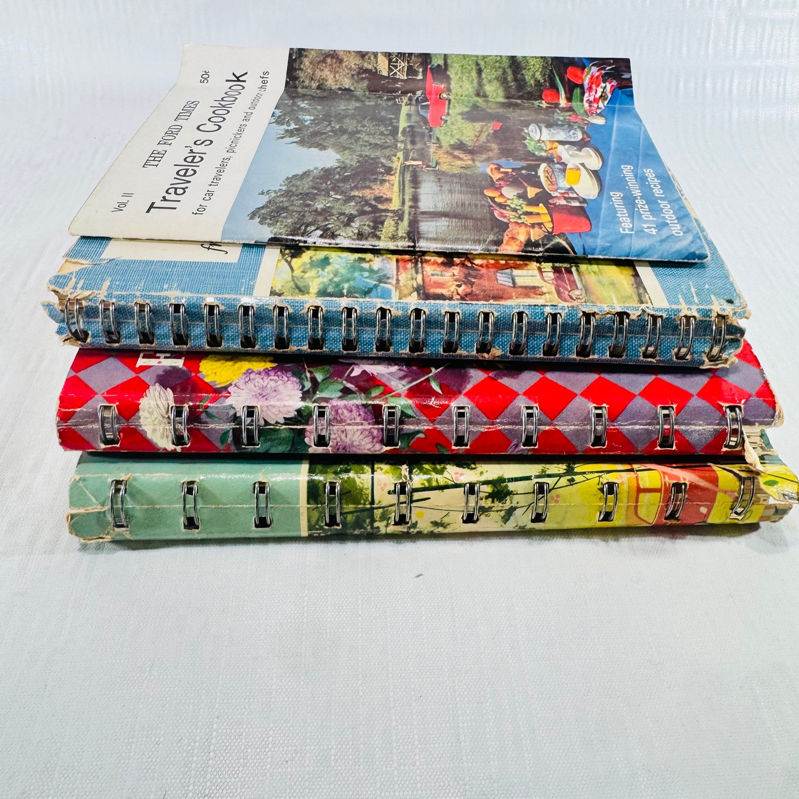 Stack of all four cookbooks with the Traveler's Cookbook on top