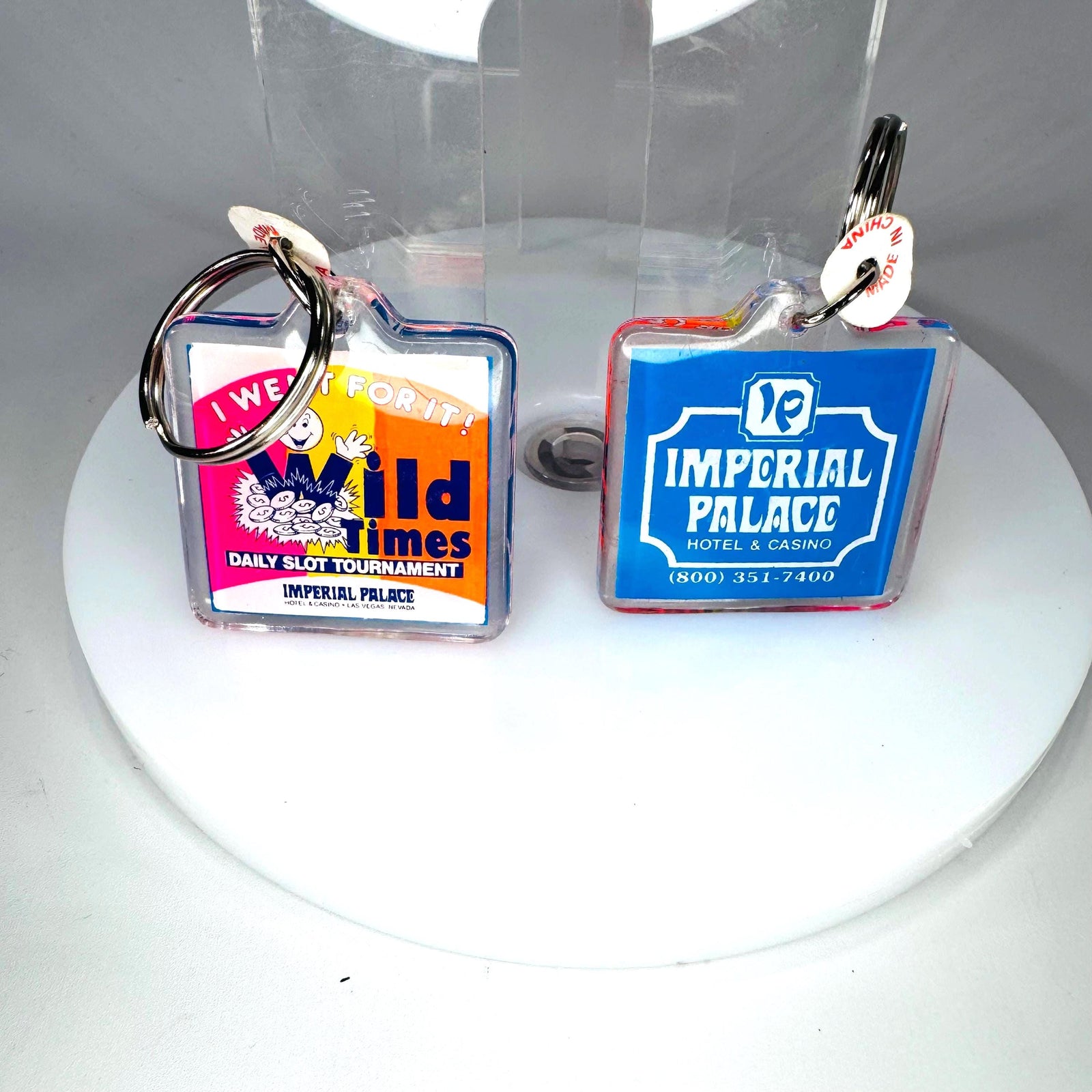 Matching vintage Imperial Palace Las Vegas casino keychains showing identical hotel logo and Old Times slot tournament designs