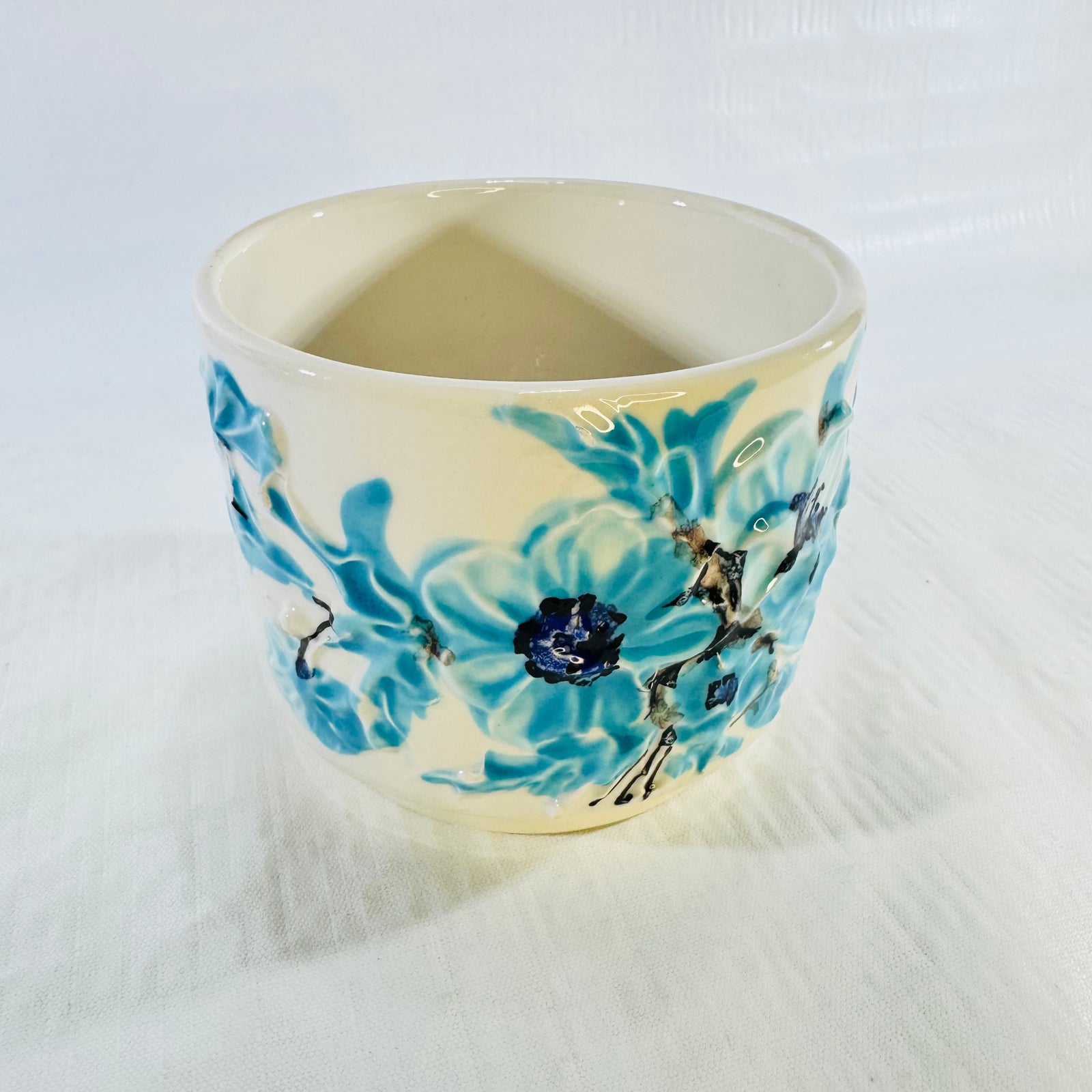 Angled front view of vintage Italian blue floral pottery planter
