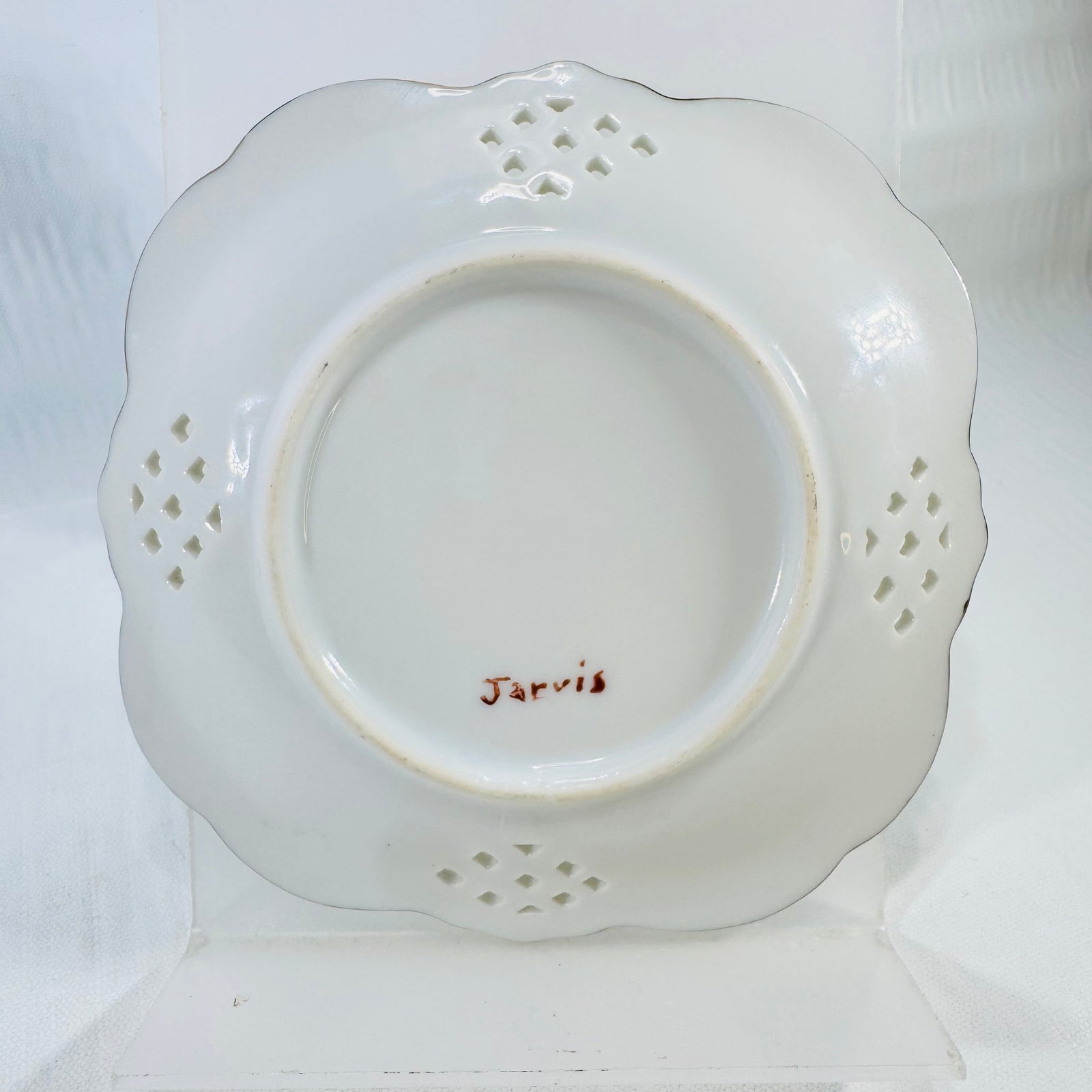 Back of the porcelain lattice dish showing the Jarvis signature and the foot ring.