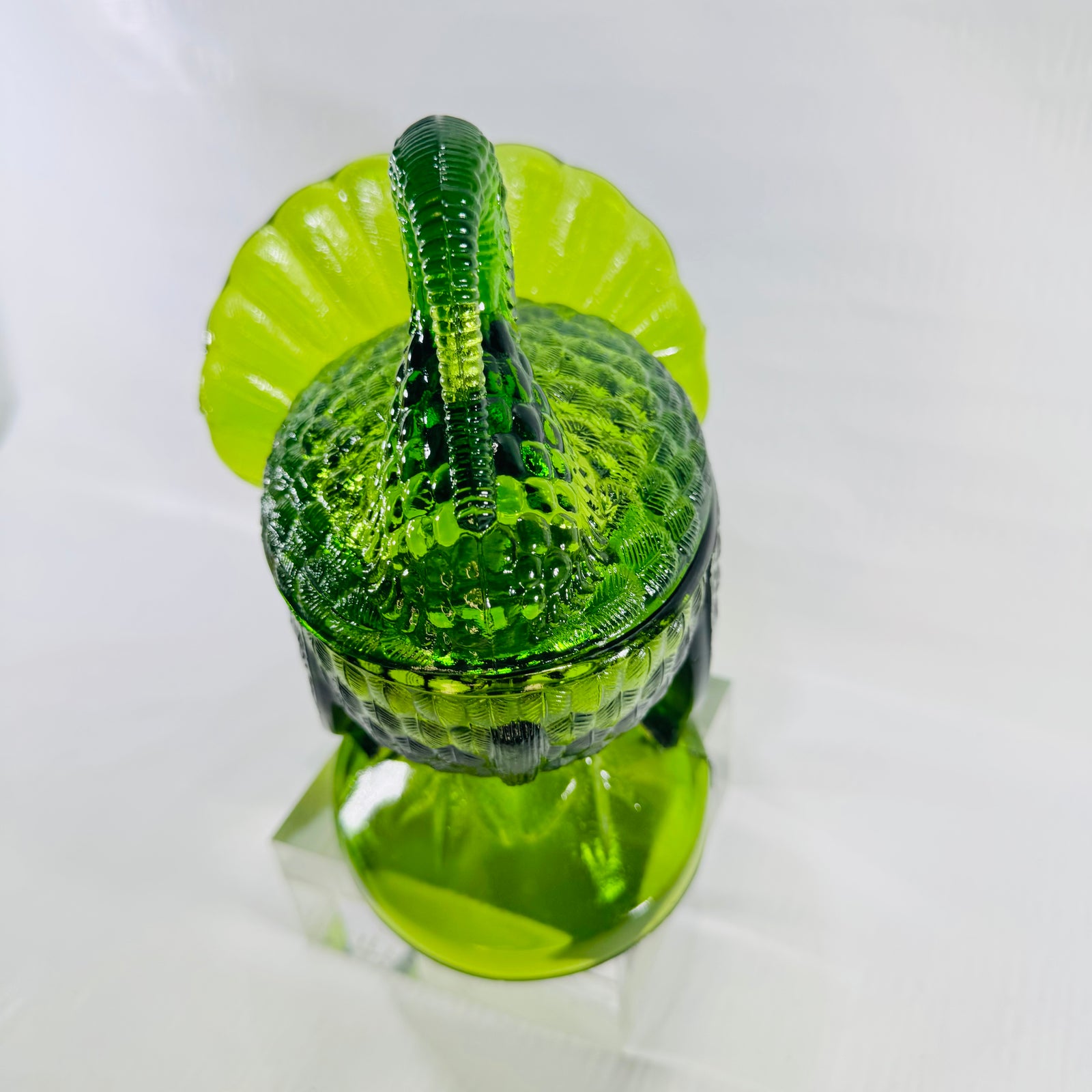 Head-on view of the green glass turkey covered dish showing neck and wattle