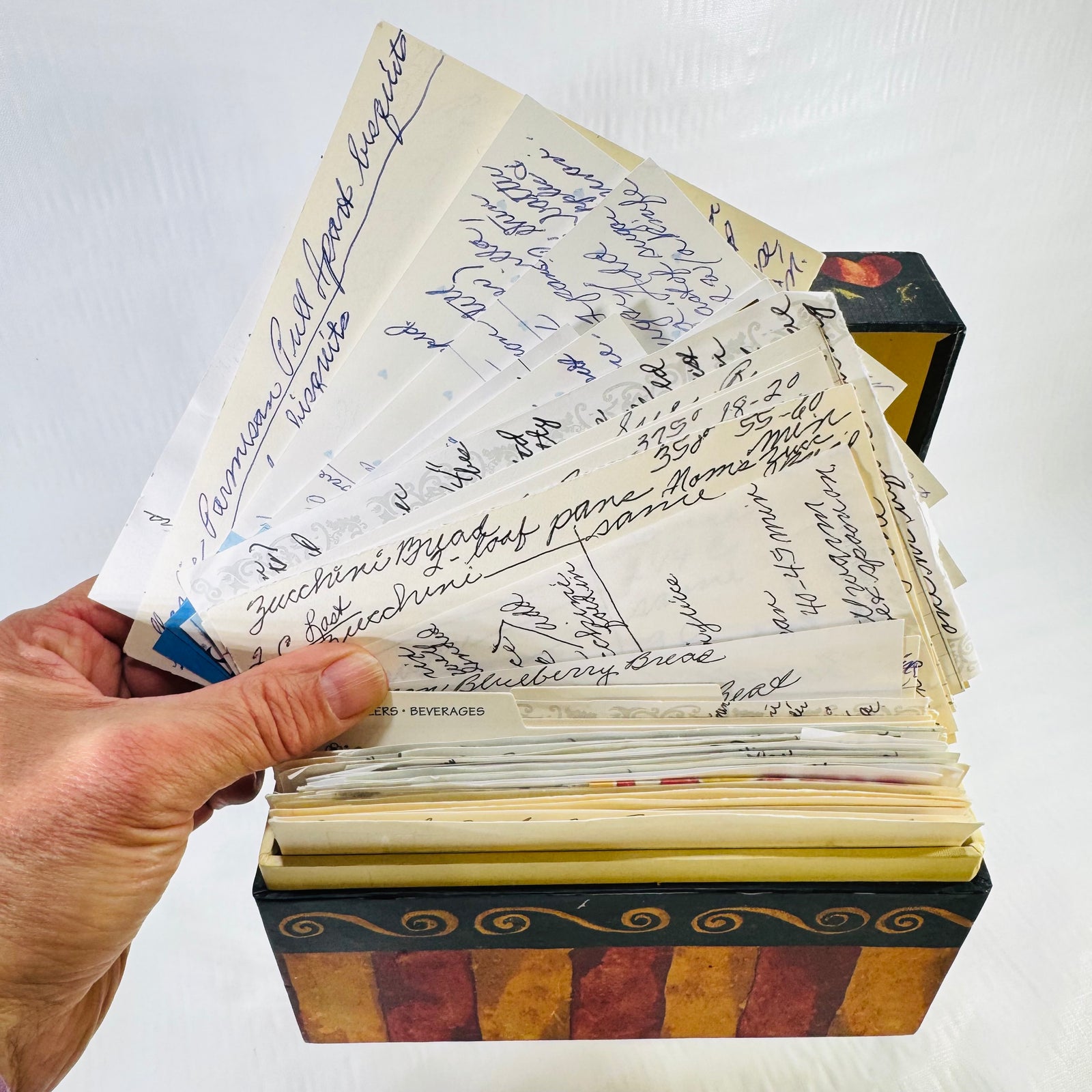 Handwritten family recipe cards fanned out from the Main Street Press recipe box