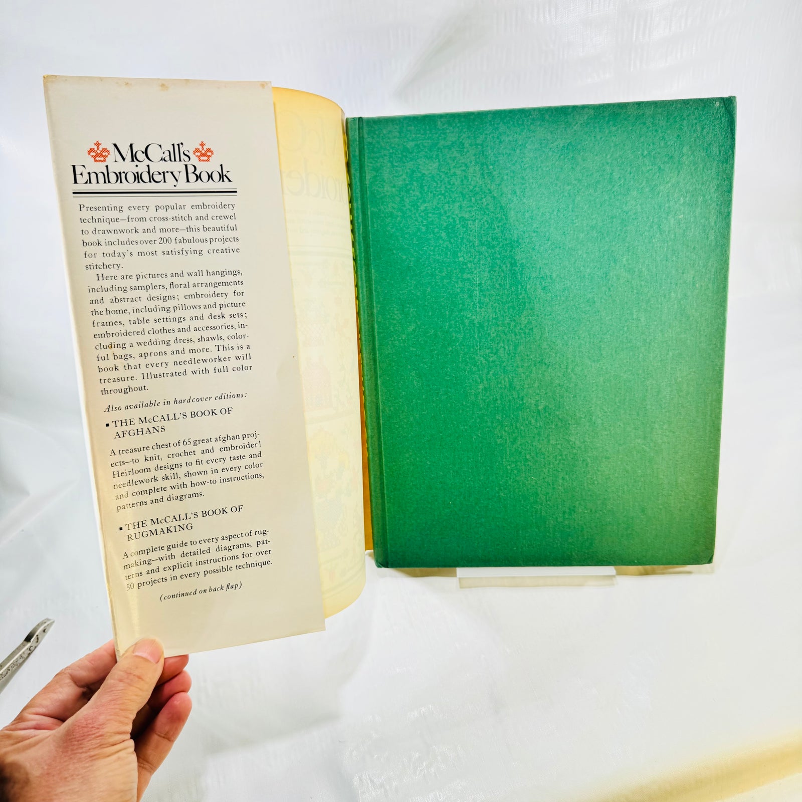 McCall's Embroidery Book front jacket flap and green cloth hardcover board