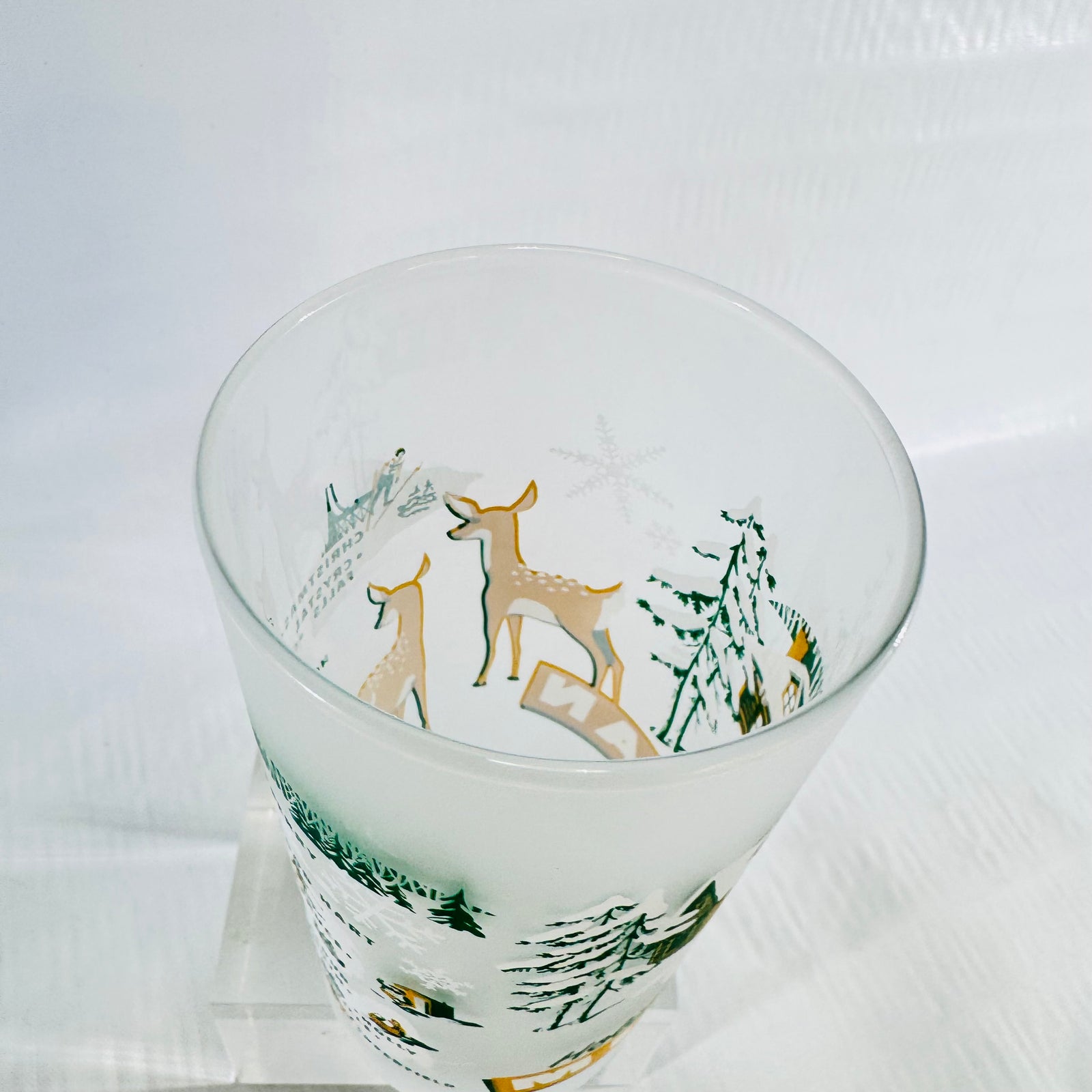 High angle view into the rim of the frosted tumbler showing the fawns and snowflakes.