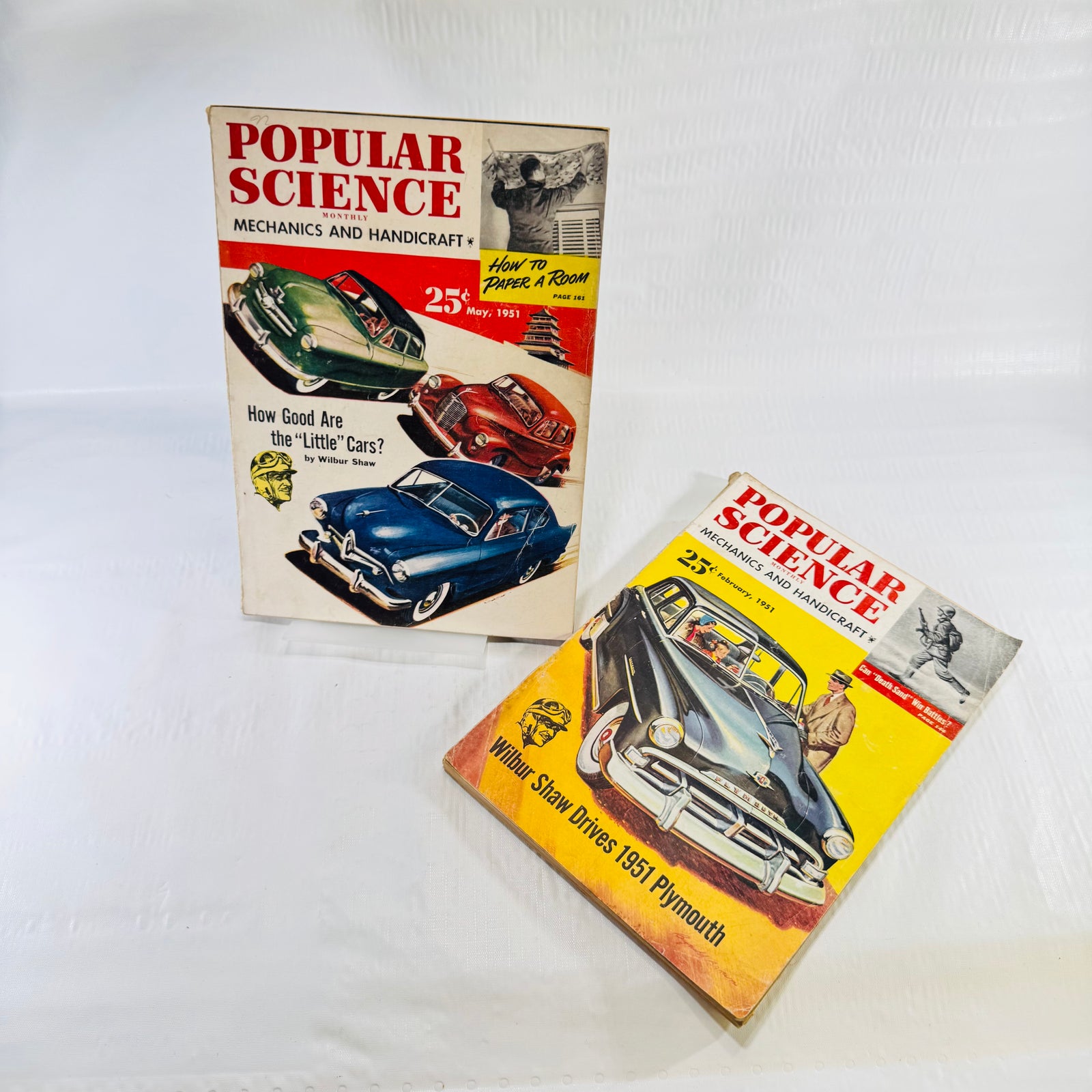 Popular Science Monthly February and May 1951 magazines shown together, May Little Cars cover upright
