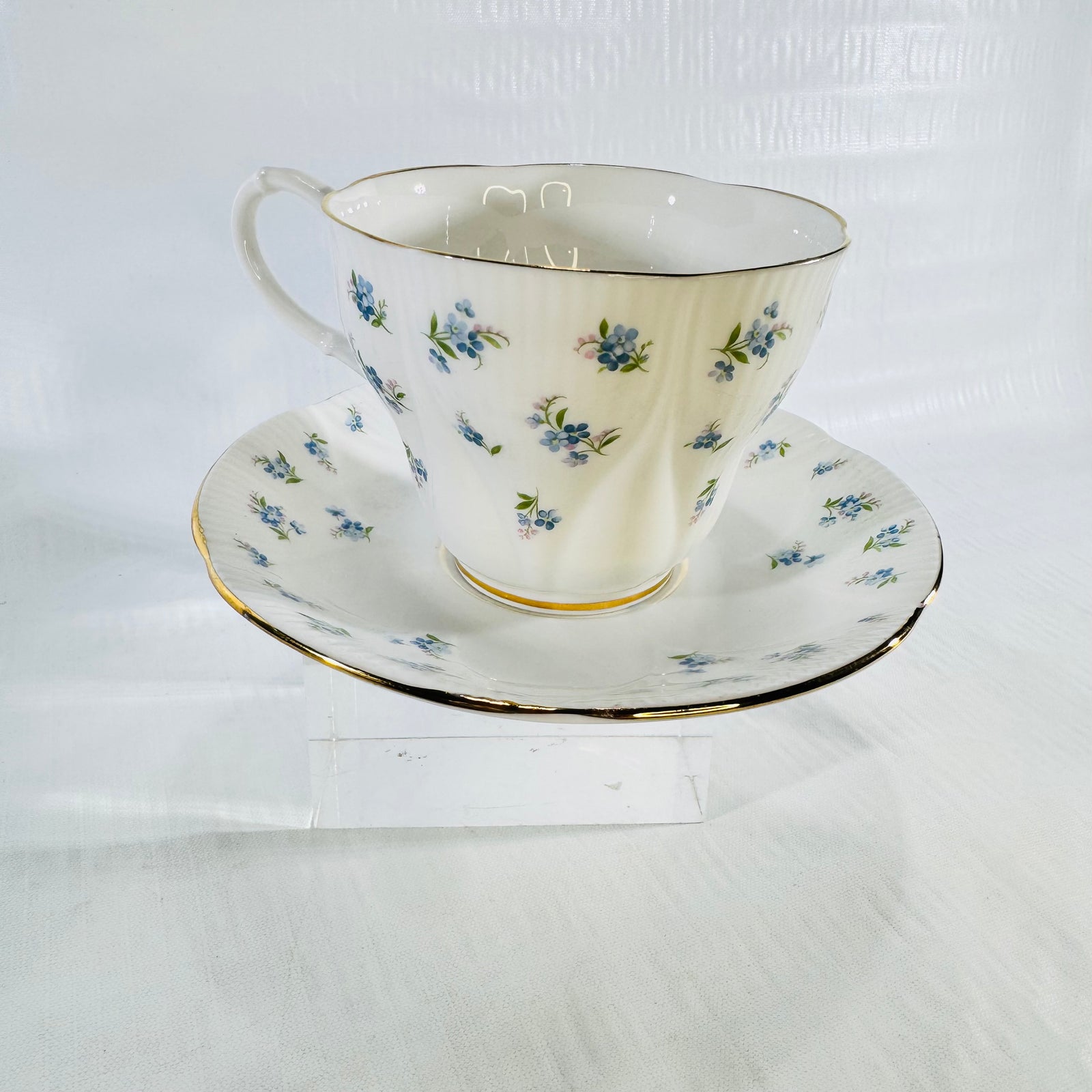 High angle photo of the Royal Albert Blue Heaven teacup and saucer set on a clear riser