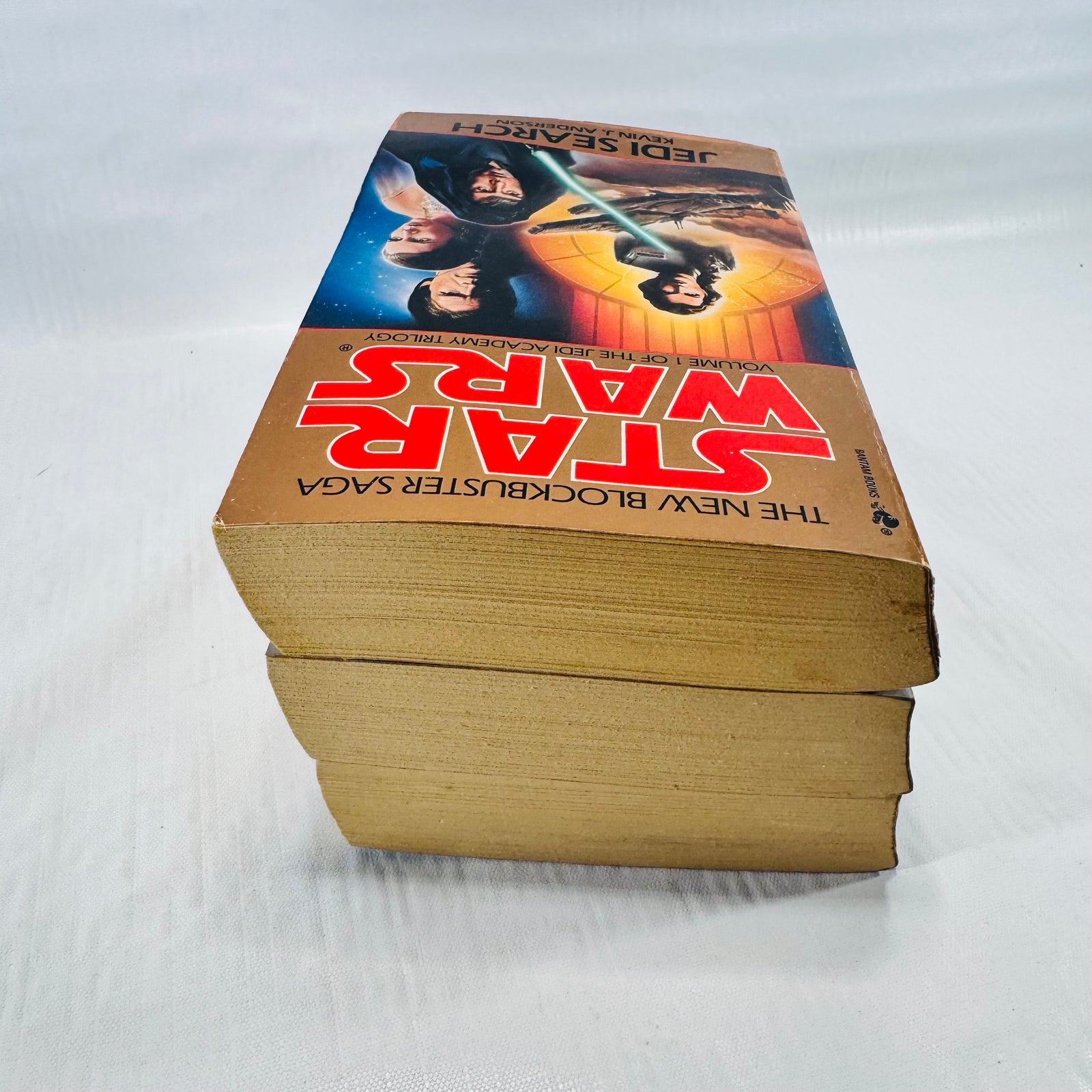 Top edges of the three stacked Jedi Academy Trilogy paperbacks.