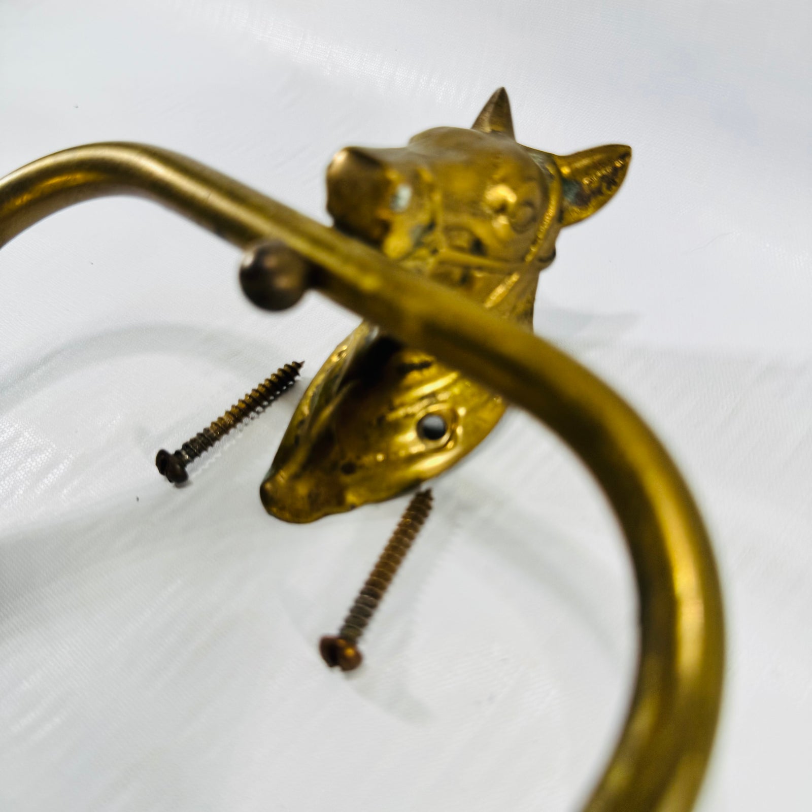 Close-up of the cast brass horse head with bridle detail and mounting screws