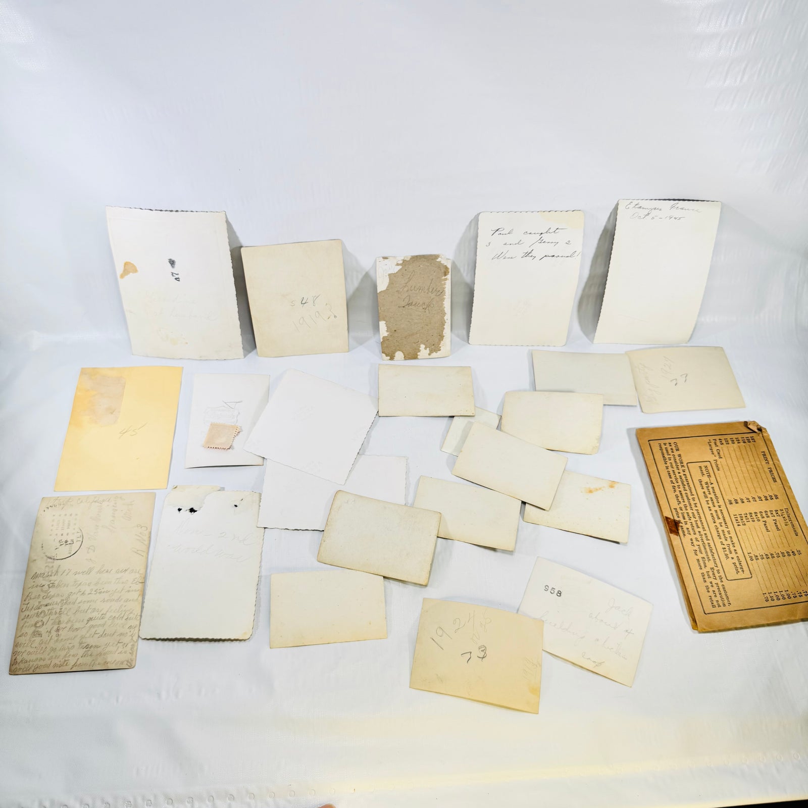 Backs of all pieces in the vintage snapshot lot with handwritten notes