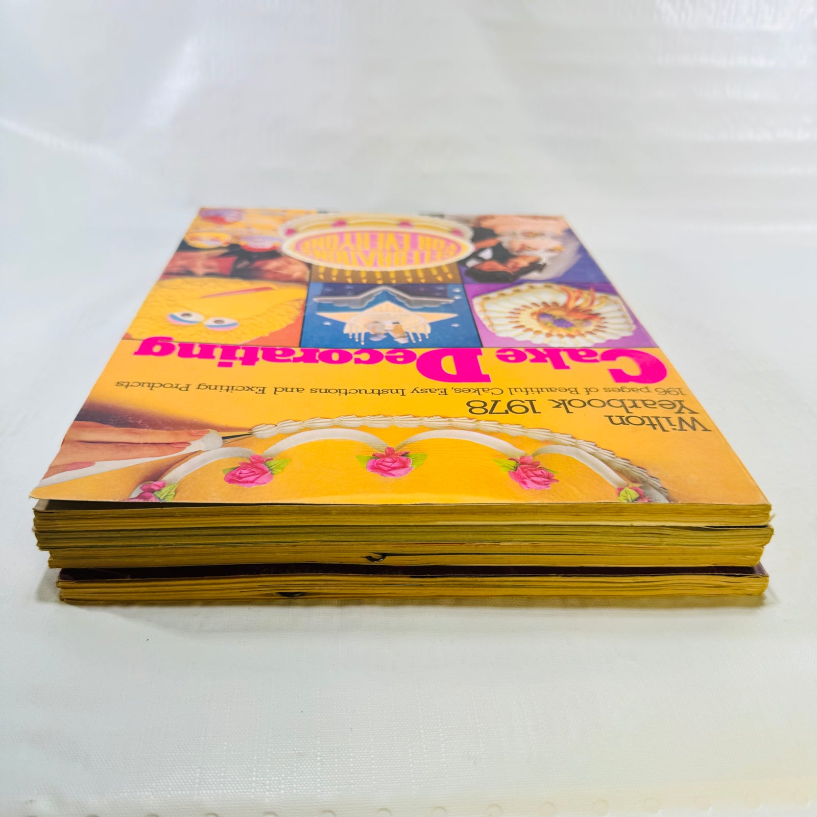 Edge view of the stacked Wilton Yearbooks showing toned page edges