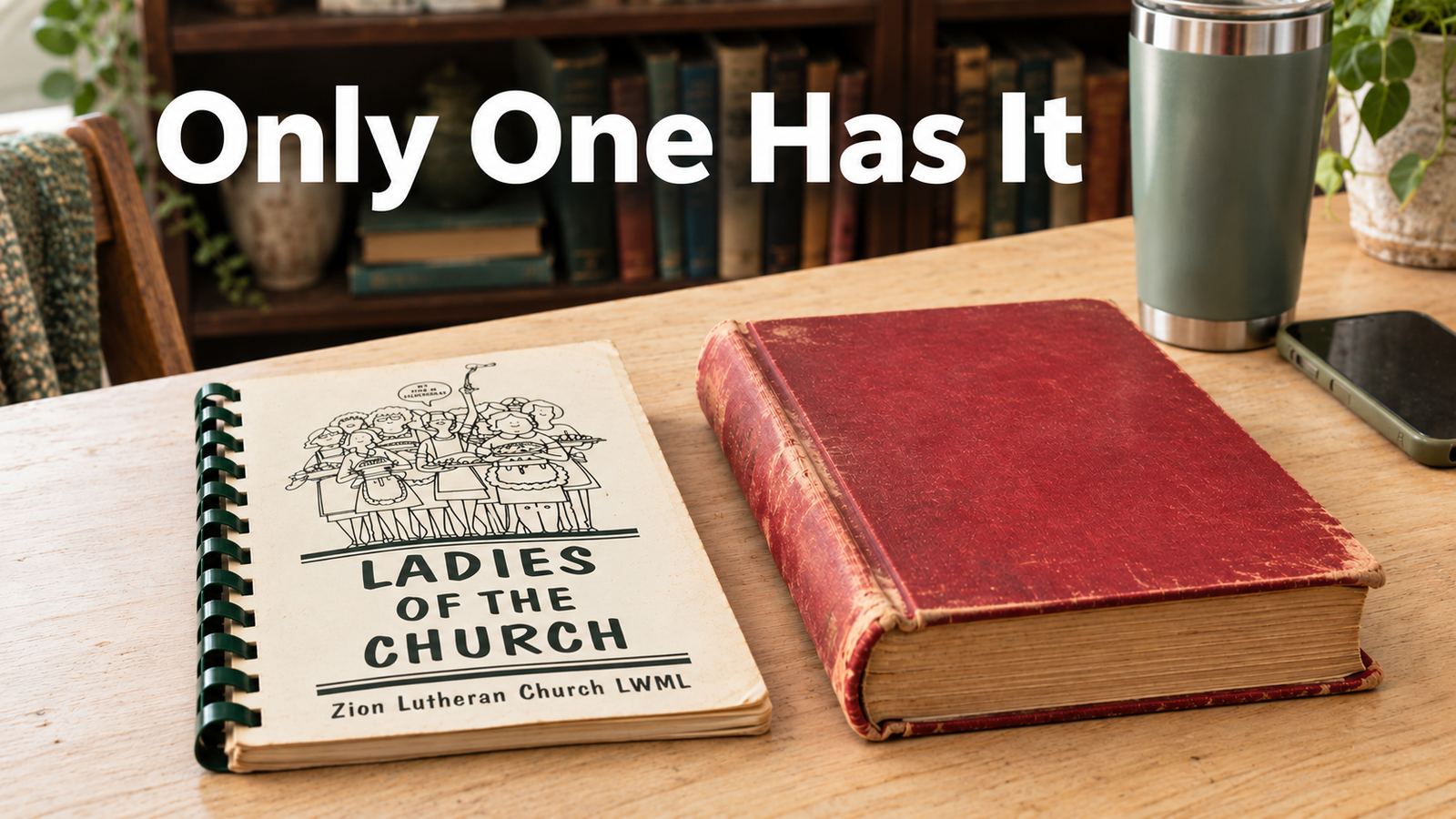 A spiral bound church community cookbook and a red hardcover Betty Crocker cookbook lying side by side on a pale wood kitchen table.
