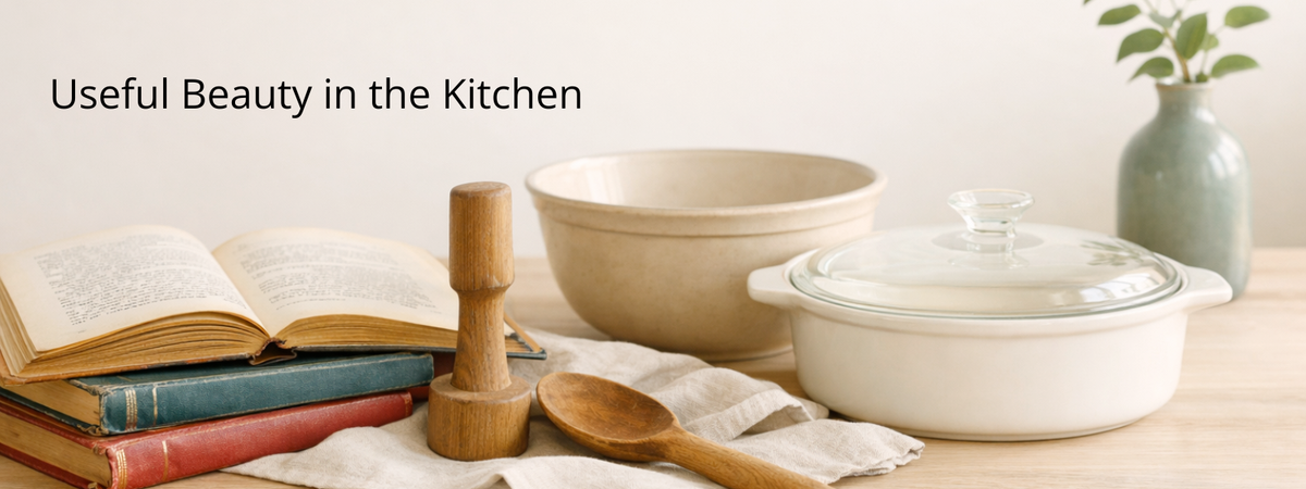 Vintage cookbooks, mixing bowl, wooden kitchen tool, and casserole dish arranged