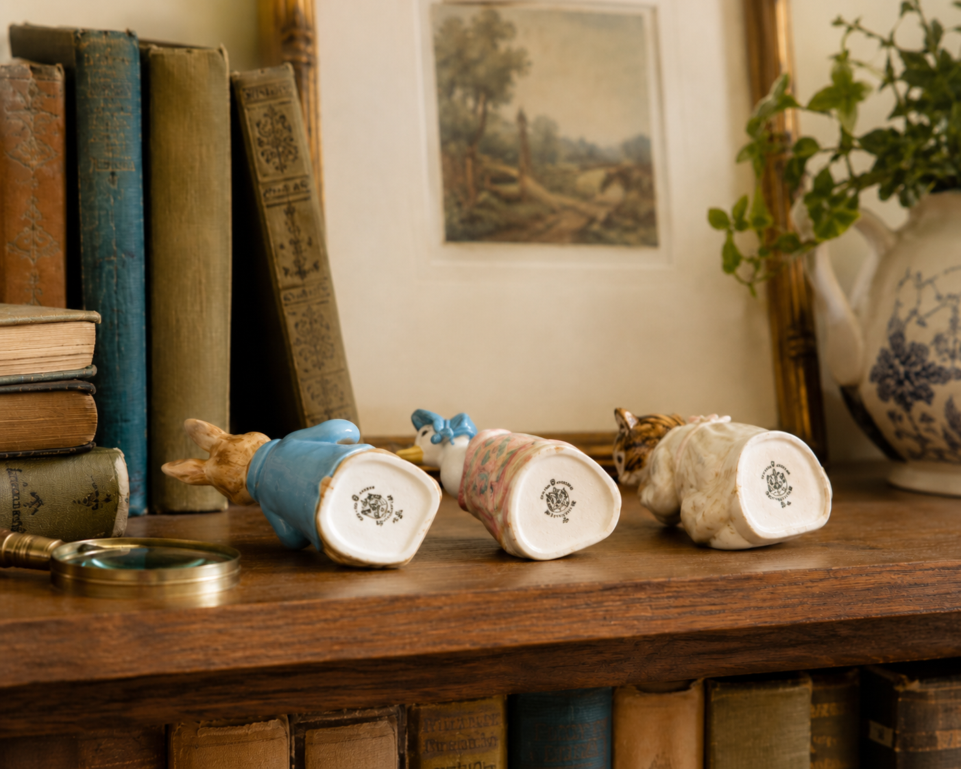 Three vintage Beswick Beatrix Potter figurines lined up on a wood shelf, showing different backstamp eras side by side