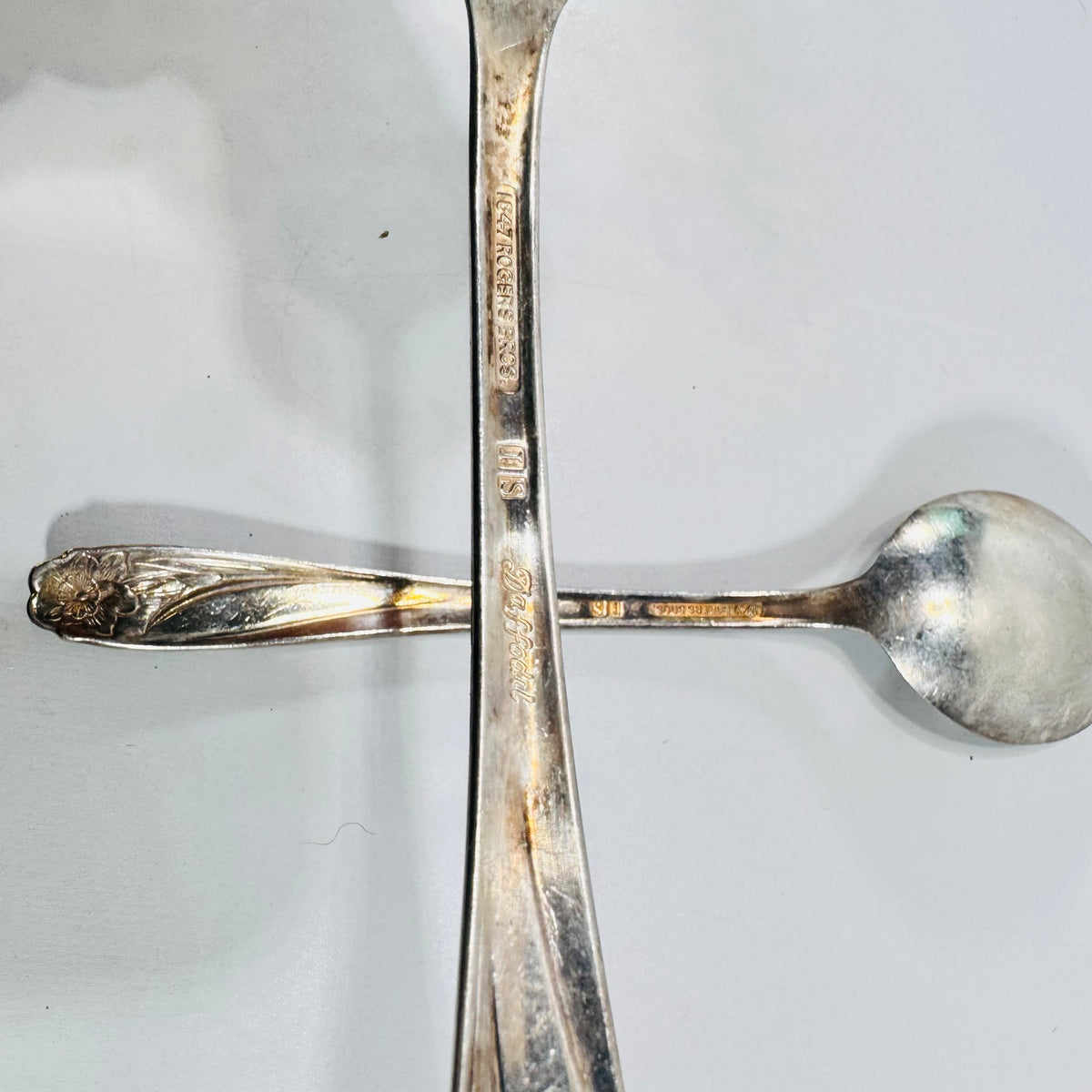 Close view of 1847 Rogers Bros IS Daffodil marks on silverplate spoon