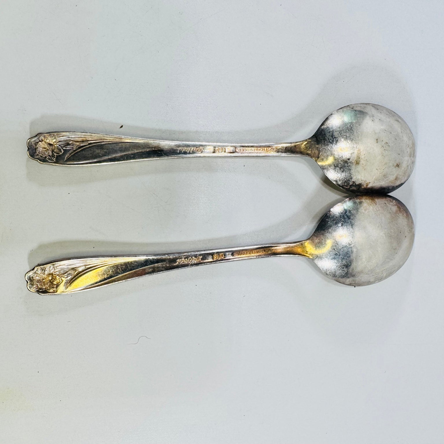 Two 1847 Rogers Bros Daffodil silverplate oval soup spoons, front view