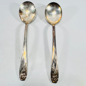 Two 1847 Rogers Bros Daffodil silverplate oval soup spoons, front view