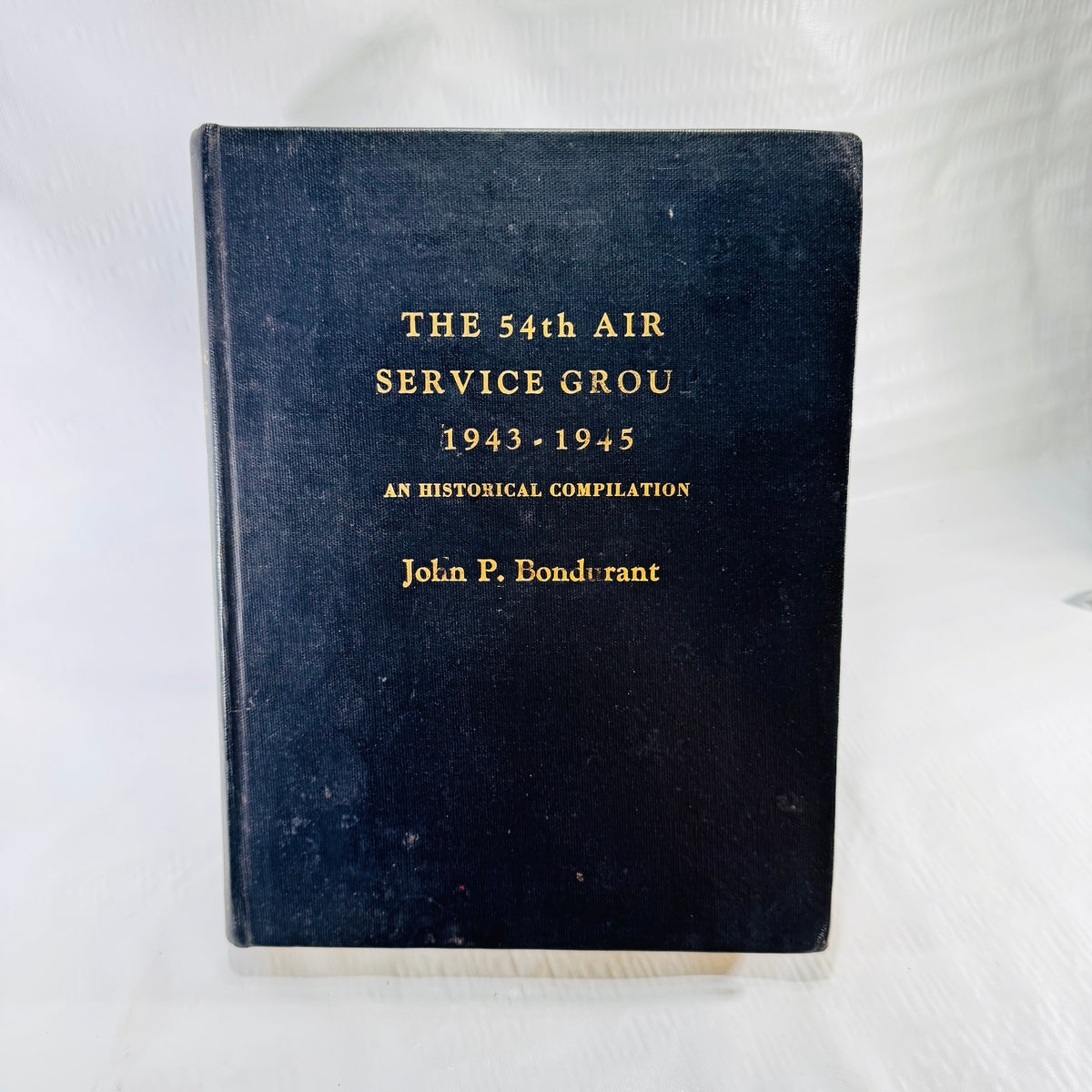 The 54th Air Service Group 1943-1945 front cover, black cloth with gilt lettering
