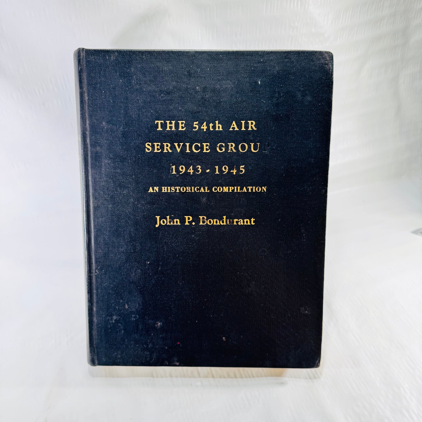 The 54th Air Service Group 1943-1945 front cover, black cloth with gilt lettering
