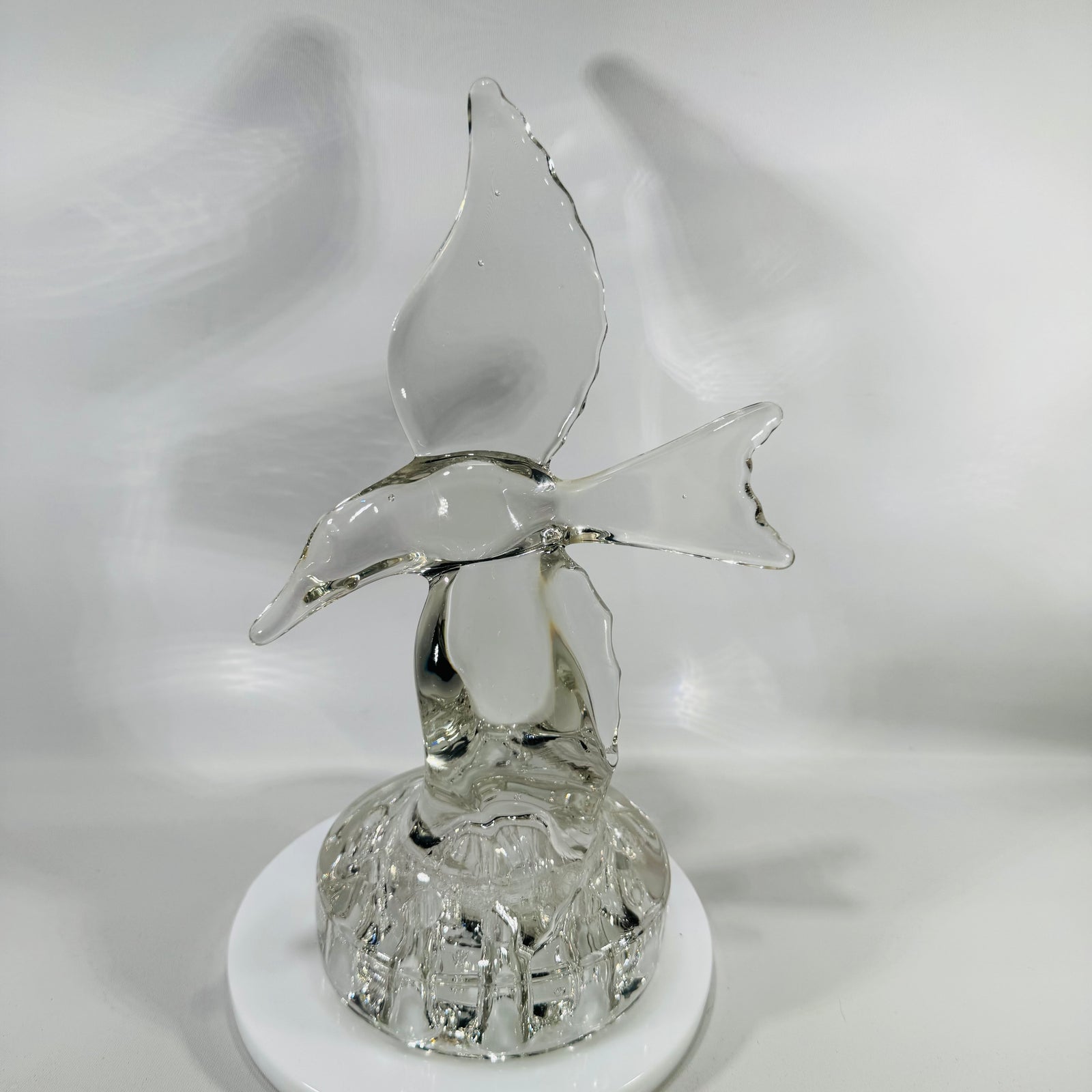 Clear vintage Cambridge crystal seagull flower frog with wings raised, perched on a clear 10-hole flower-arranging base