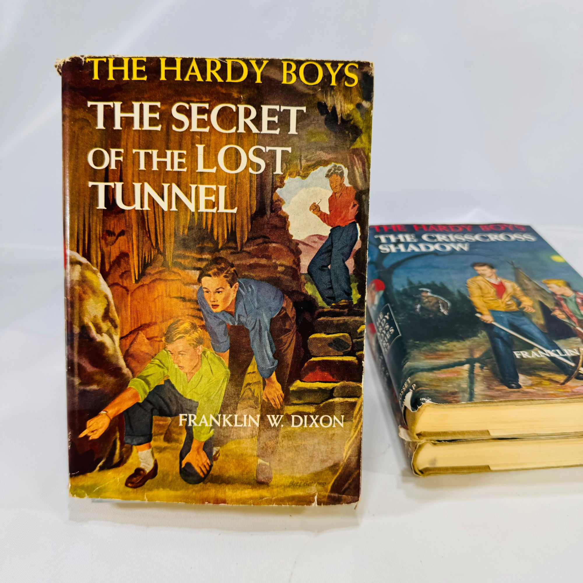 Three Hardy Boys Books by Franklin W. Dixon The Crisscross Shadow The Secret of the Lost Tunnel, The Clue in the Embers Grosset and Dunlap