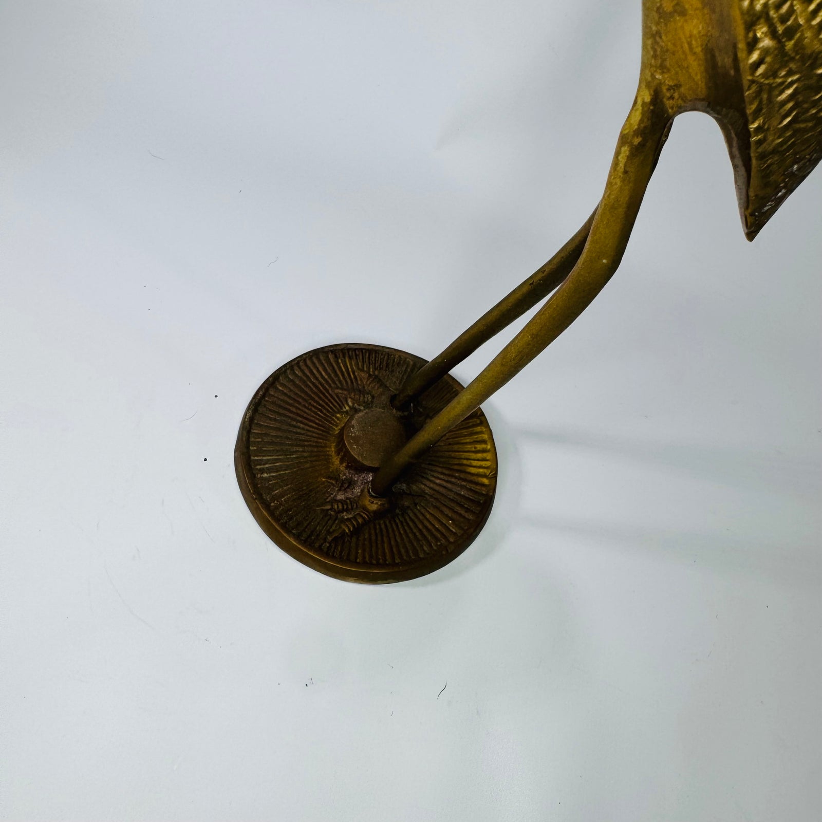 Bronze sculpture of a crane on a white background