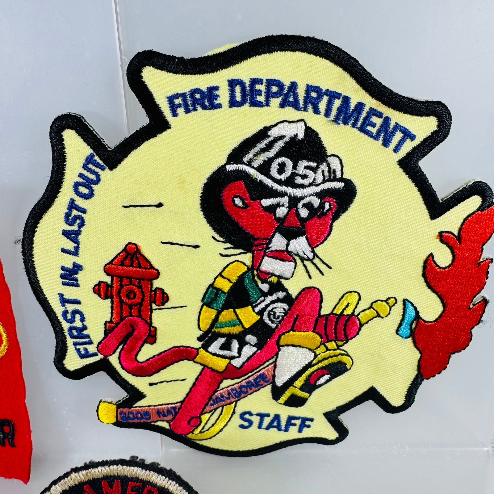 Fire department patch with cartoon character and text on a white background