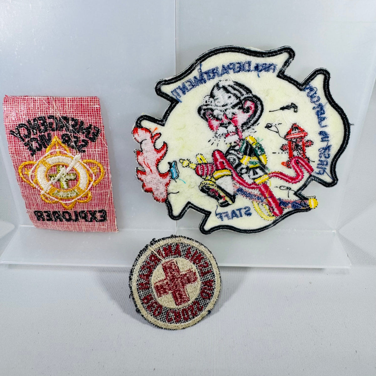Three embroidered patches on a white background