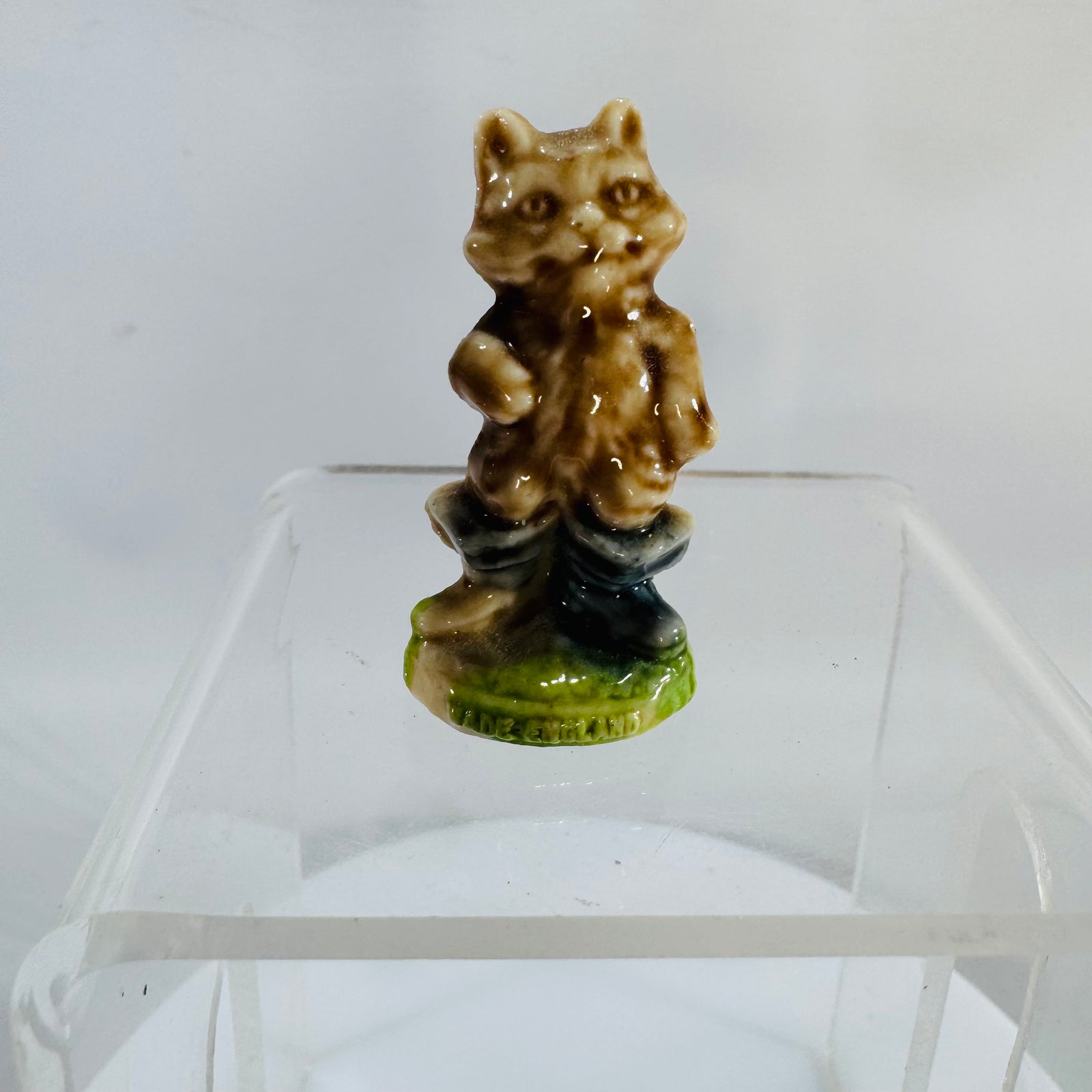 Vintage Wade Whimsies Puss in Boots porcelain mini figurine on green base with “WADE ENGLAND” mark, glossy glaze, photo shows close-up details.
