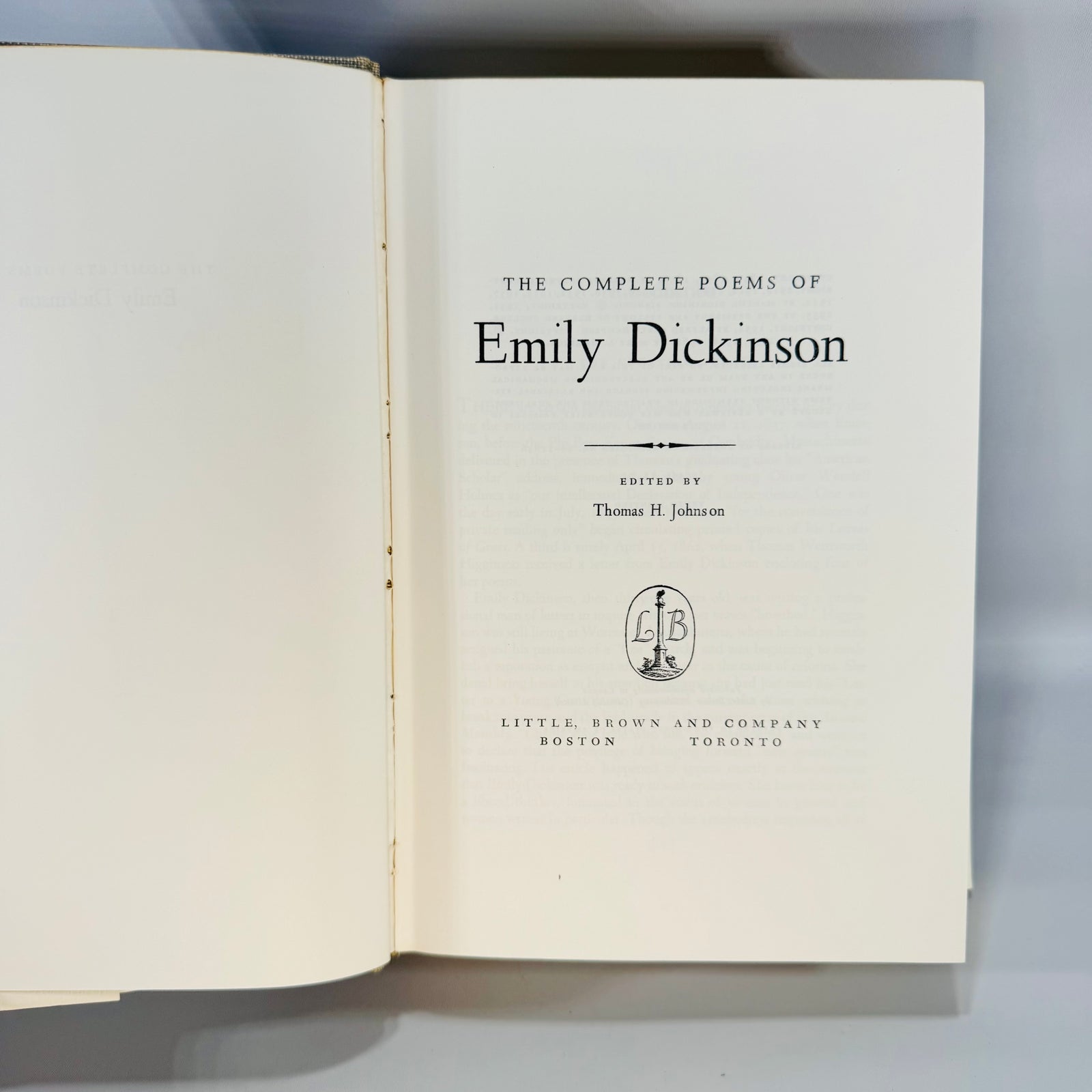 Vintage The Complete Poems of Emily Dickinson hardcover with teal and cream dust jacket, $15.00 flap price, gray cloth boards, tenth printing shown inside.