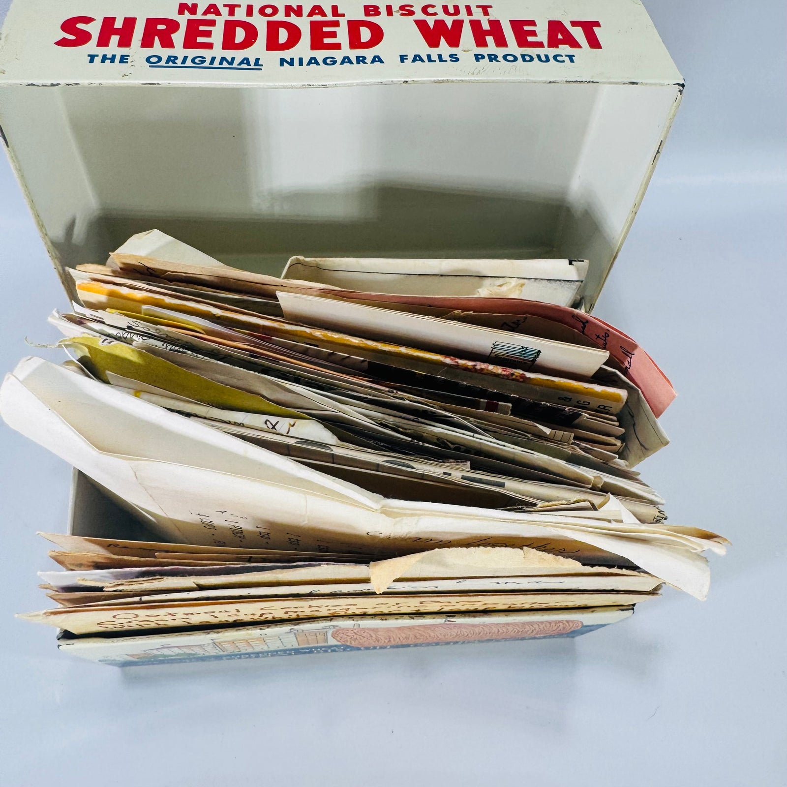 Vintage Nabisco Shredded Wheat “Recipes” box dated 1973 filled with handwritten recipe cards and newspaper clippings, estate kitchen ephemera lot.