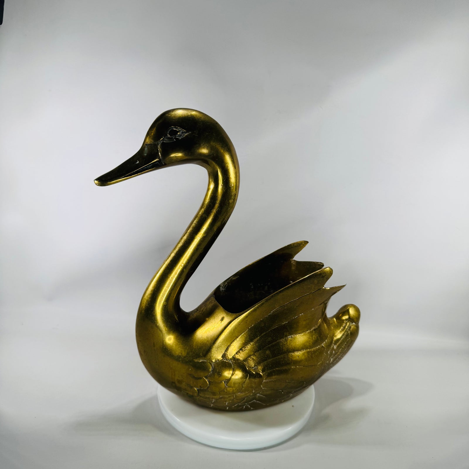 Vintage solid brass swan planter with long curved neck and detailed wings, shown in warm gold tone