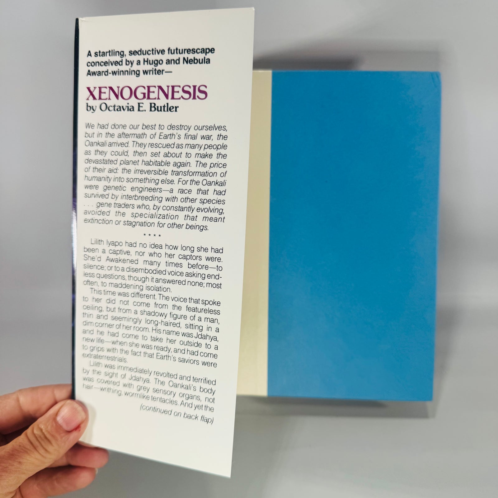  Xenogenesis by Octavia E. Butler—vintage science fiction hardcover with black starry jacket, purple spine, and illustrated Earth-and-figures artwork.