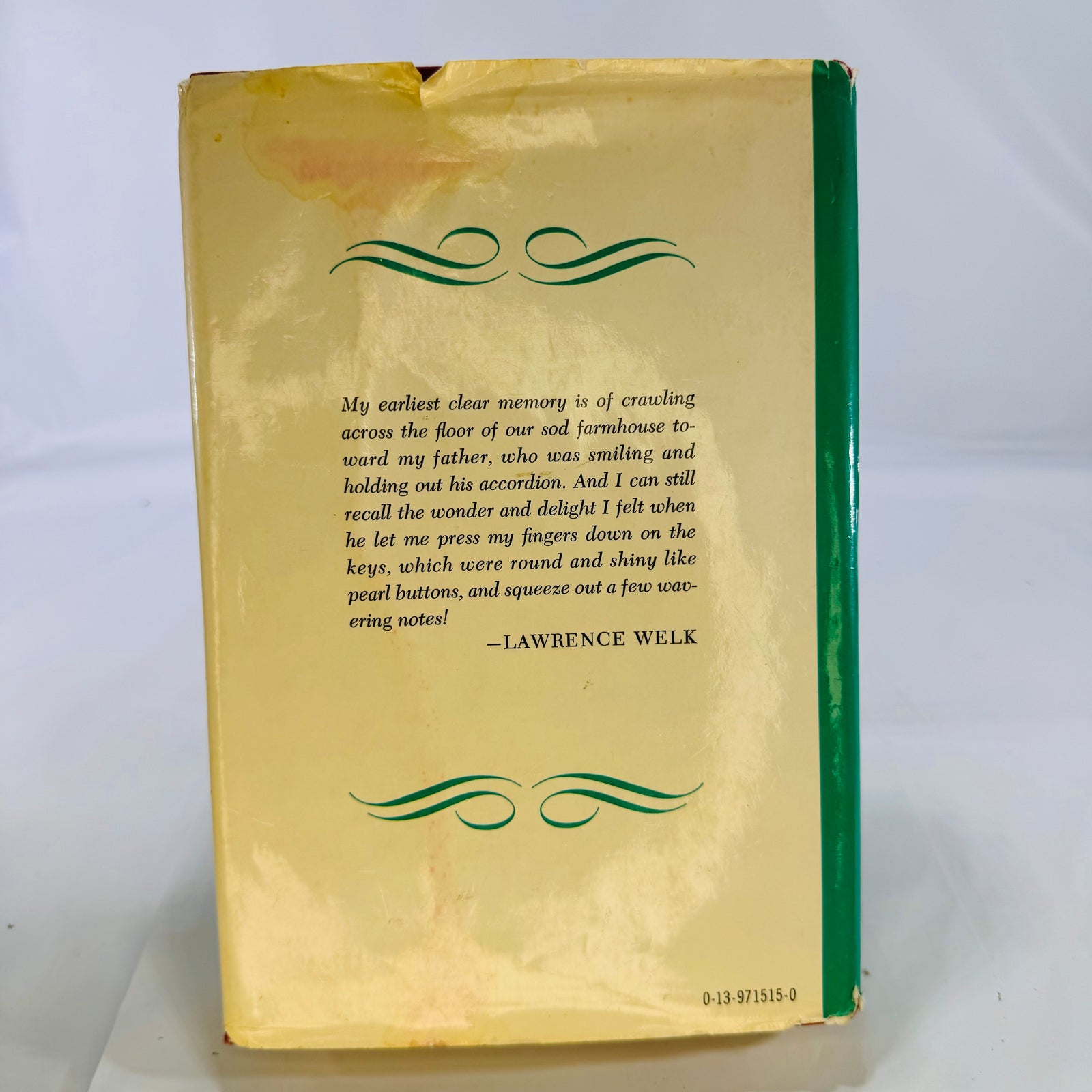 Back of the dust jacket with a Lawrence Welk quote and staining