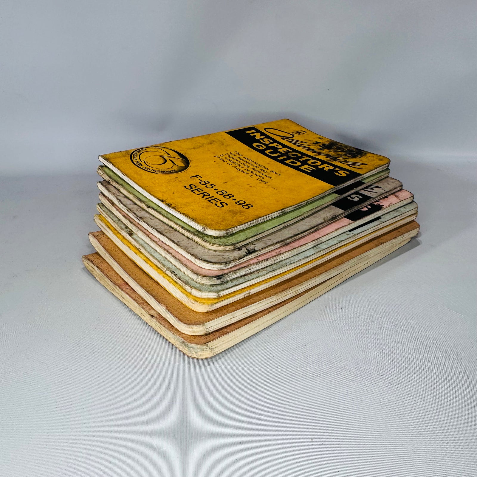 Vintage Oldsmobile Inspector’s Guide Lot (1973–1979) — 8 Pocket Manuals, Codes & Specs (Cutlass / 88 / 98 / F-85 / A-B-C)