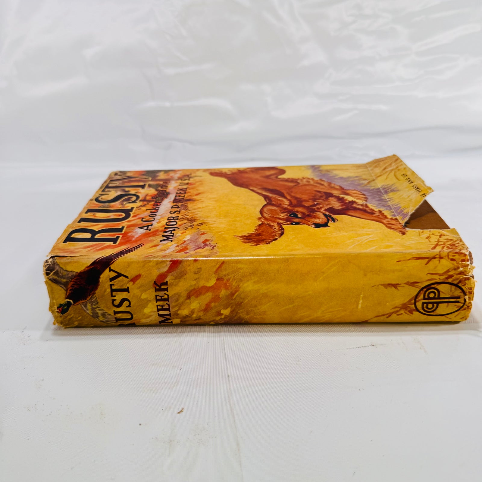 Dust jacket spine of Rusty, A Cocker Spaniel with chipped ends