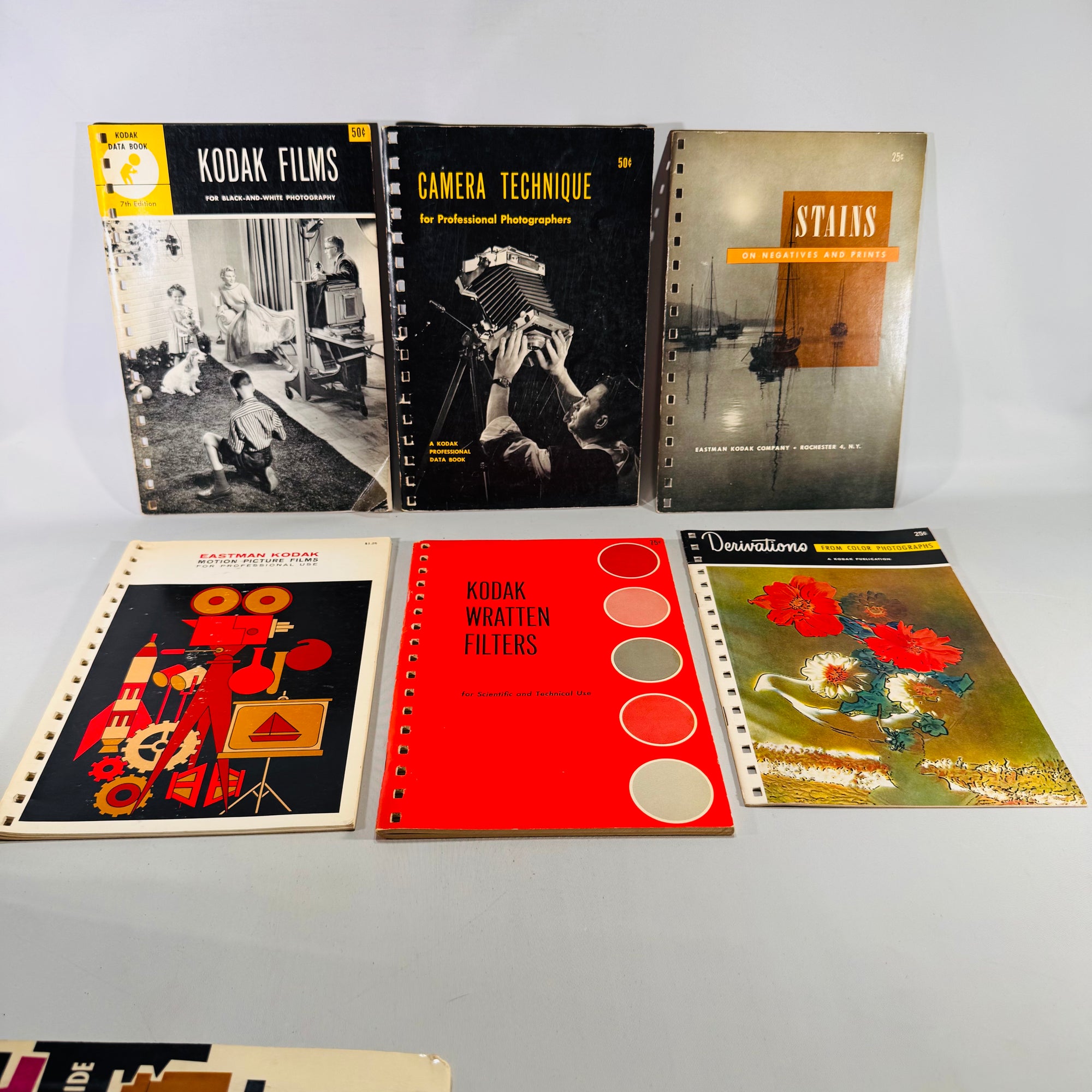 Collection of vintage photography books and manuals on a gray background