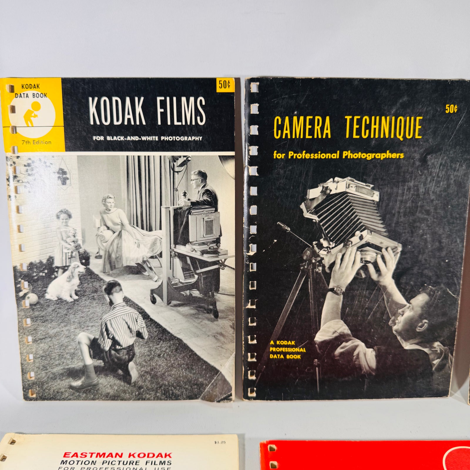 Collection of vintage photography books and manuals on a gray background
