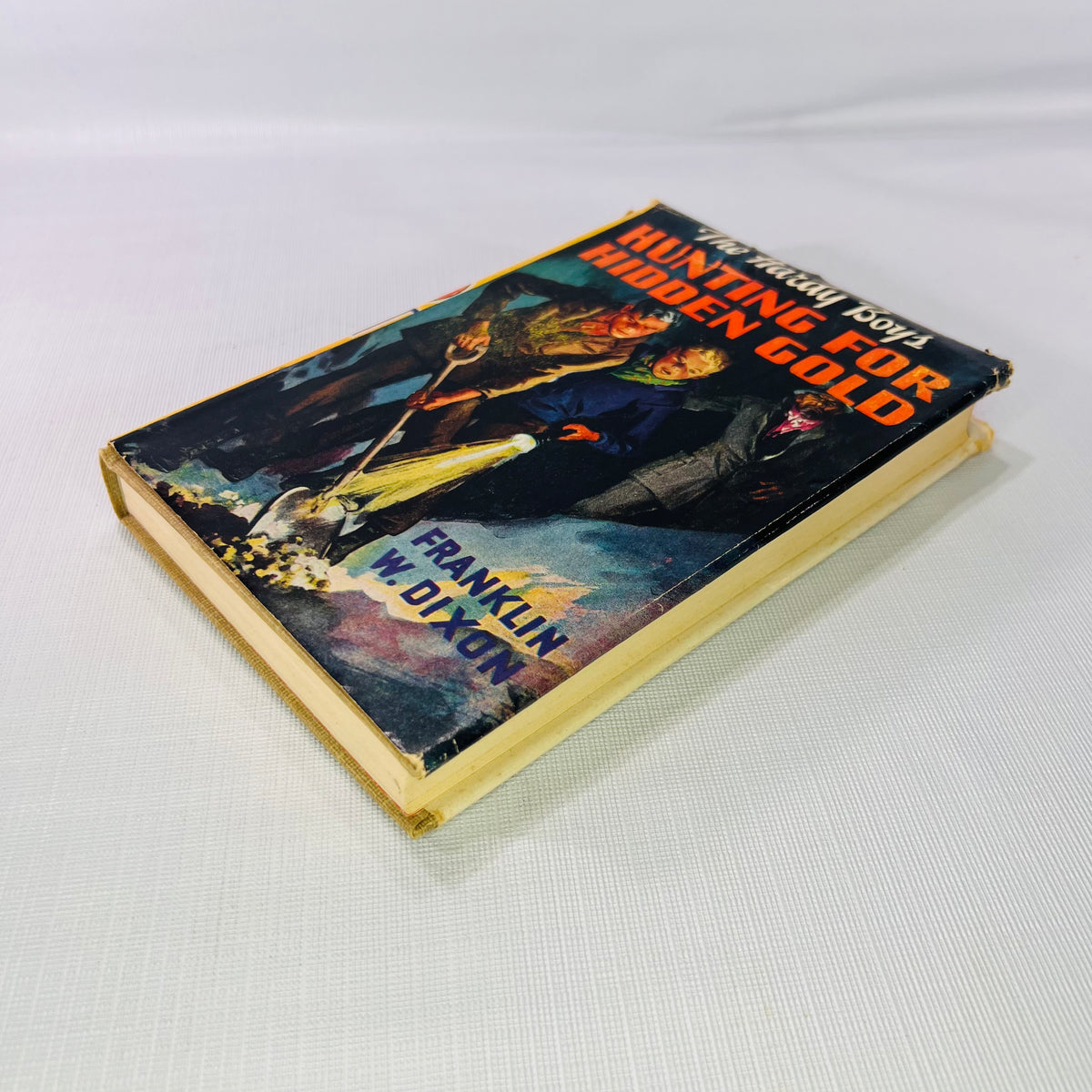 Hunting for Hidden Gold 1928 lying flat, showing the jacket front and page edges
