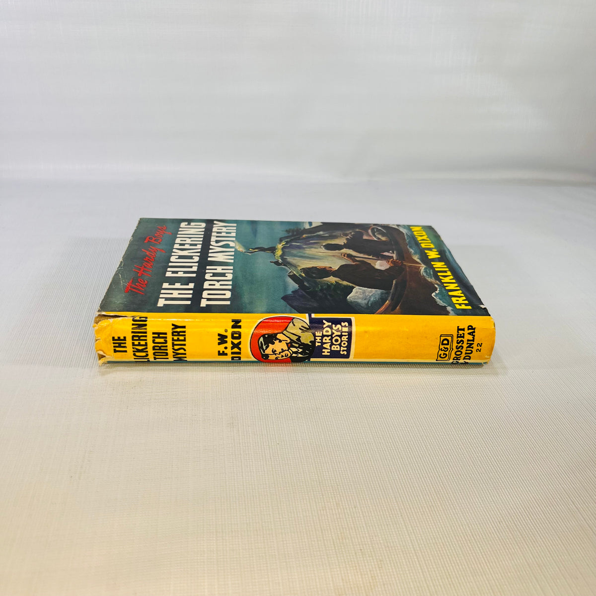 Dust jacket spine of The Hardy Boys The Flickering Torch Mystery 1943